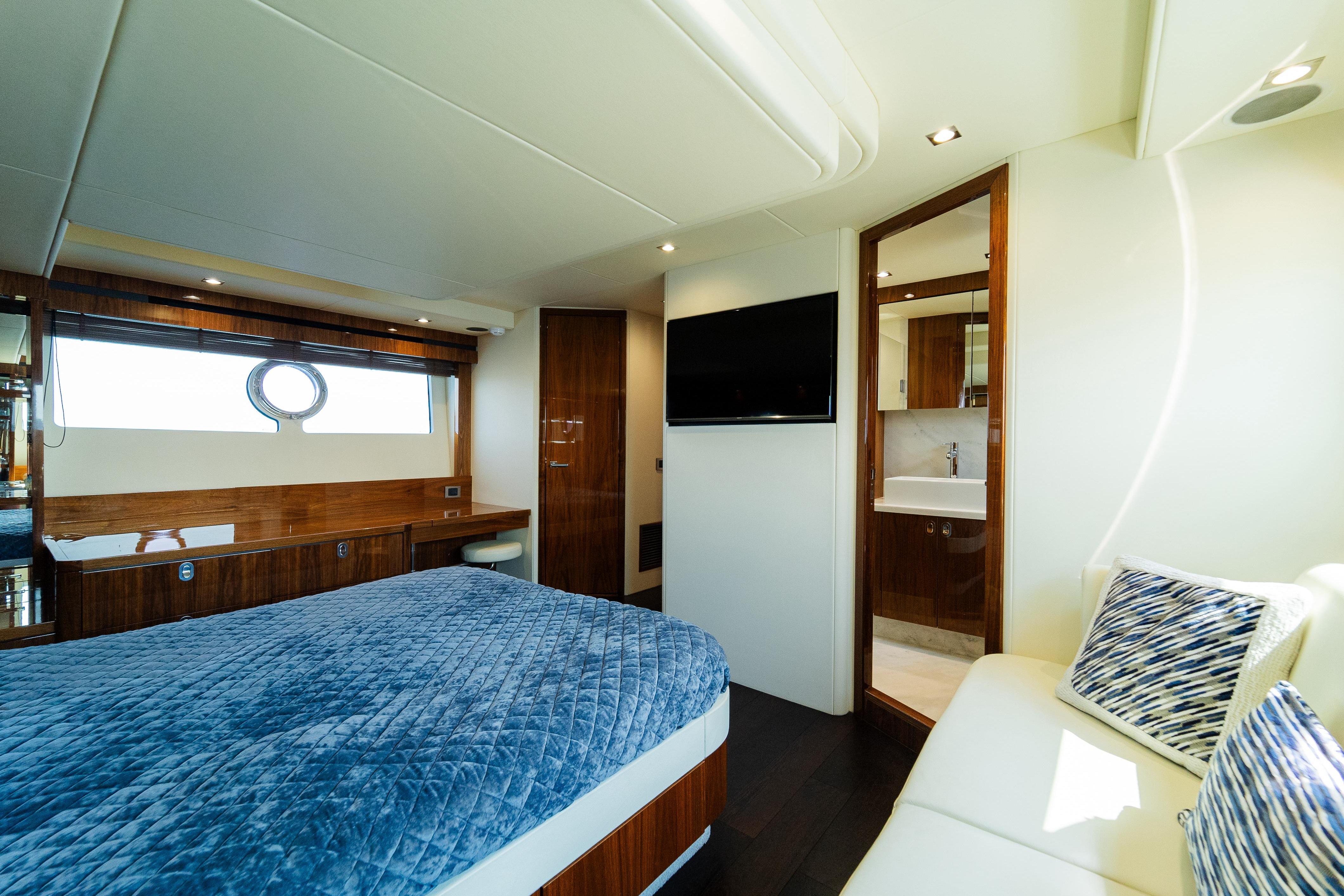 Luxurious bedroom interior of 2016 Sunseeker Manhattan 65 yacht with modern amenities.