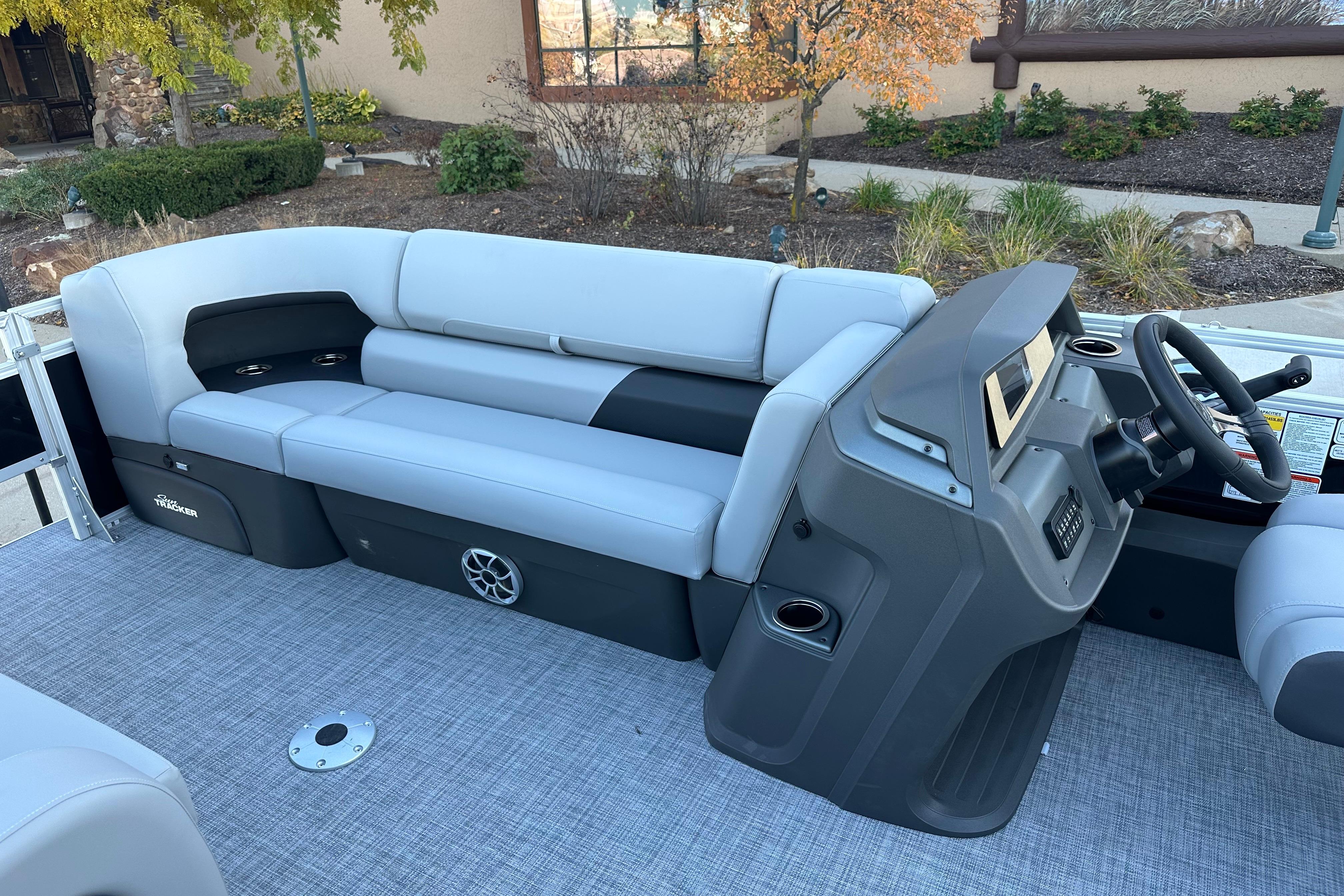 2026 Sun Tracker SportFish 22 DLX boat interior with gray seating and steering console.
