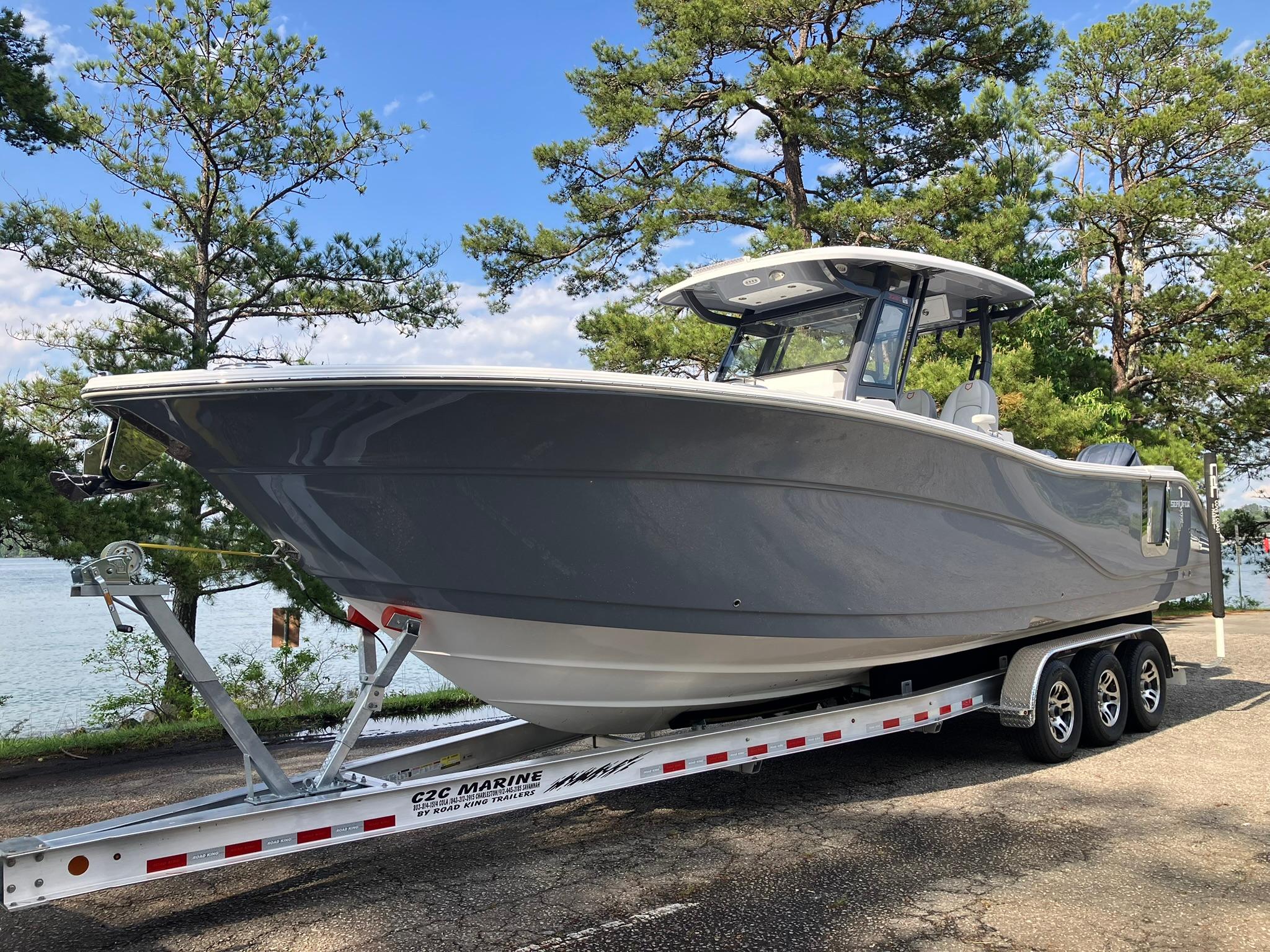 2025 Sea Fox 328 Commander boat on trailer, surrounded by trees and water.