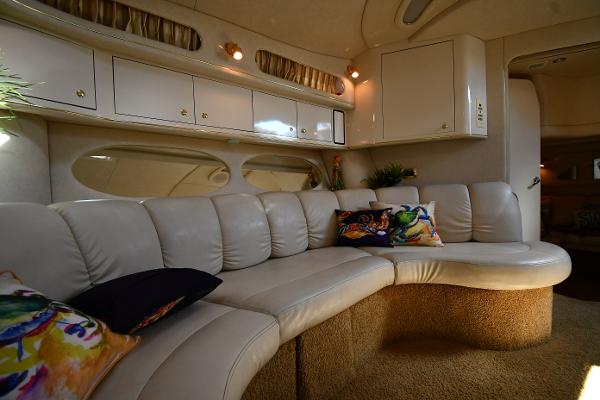 Luxurious interior of 1997 Sea Ray 400 Sundancer yacht with plush seating and vibrant cushions.