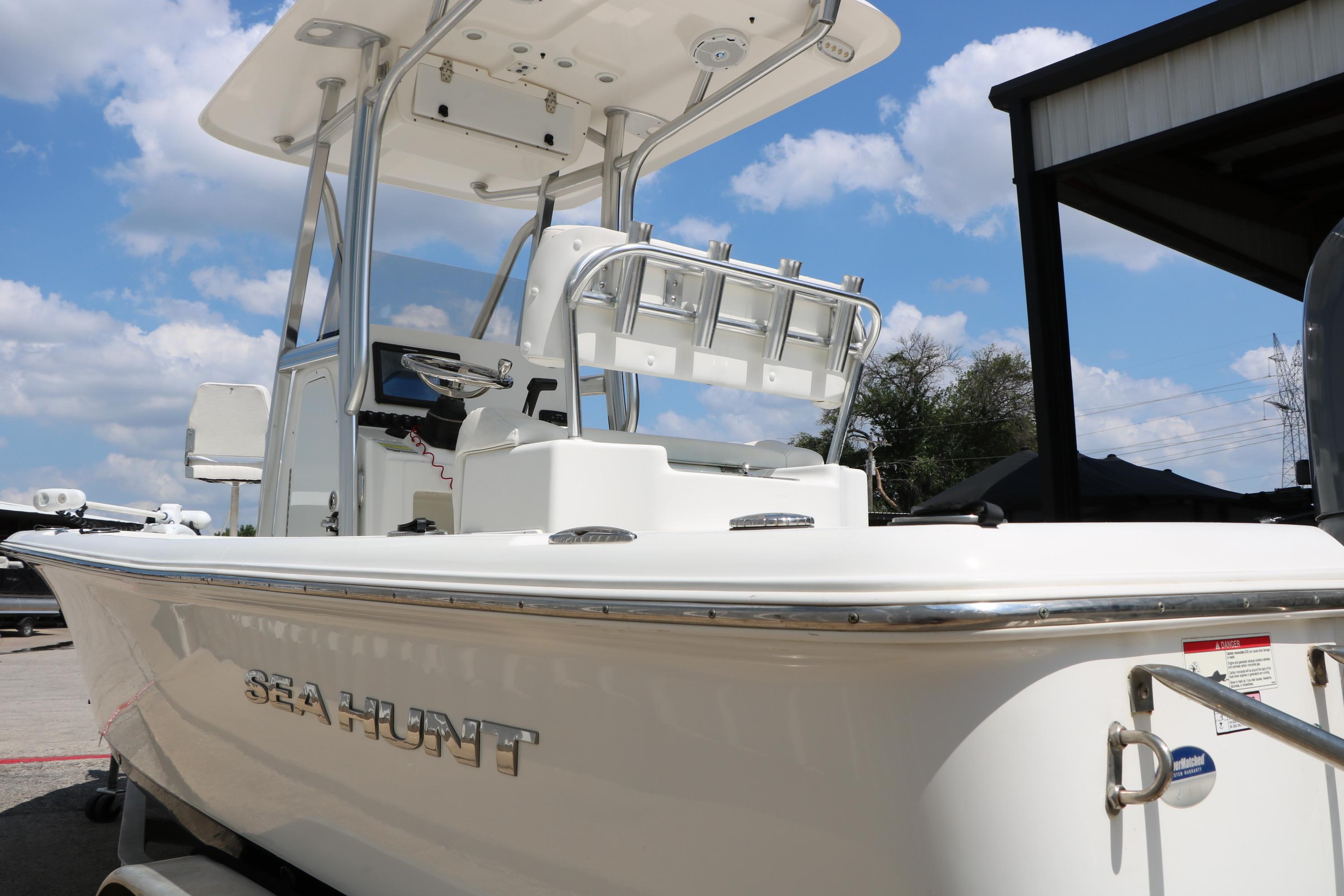 2015 Sea Hunt BX 22 BR boat with T-top under blue sky.