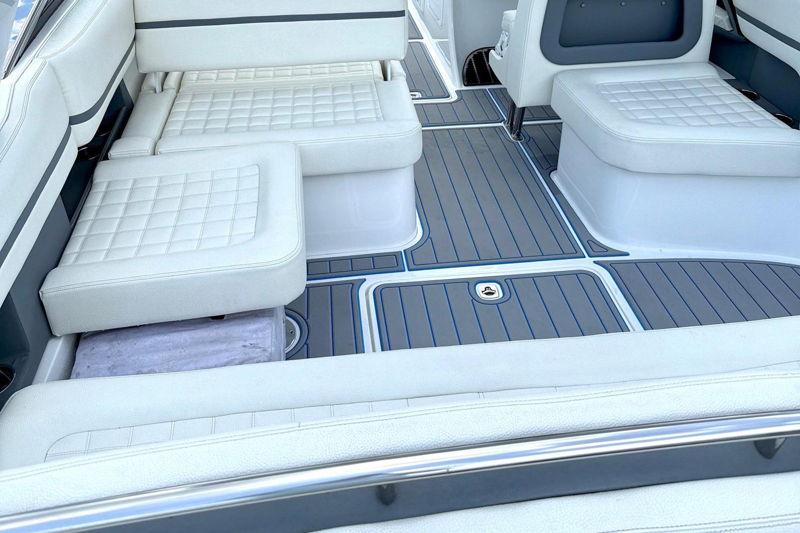 2022 Cobalt R30 boat interior with white cushioned seating and sleek flooring design.