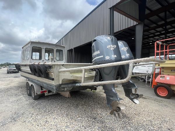 Custom Flat 28 Cabin Boat 2010 with dual Yamaha 250 engines in a storage facility.