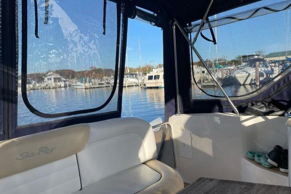 Interior view of 2008 Sea Ray 330 Sundancer at marina, showcasing seating and windows.