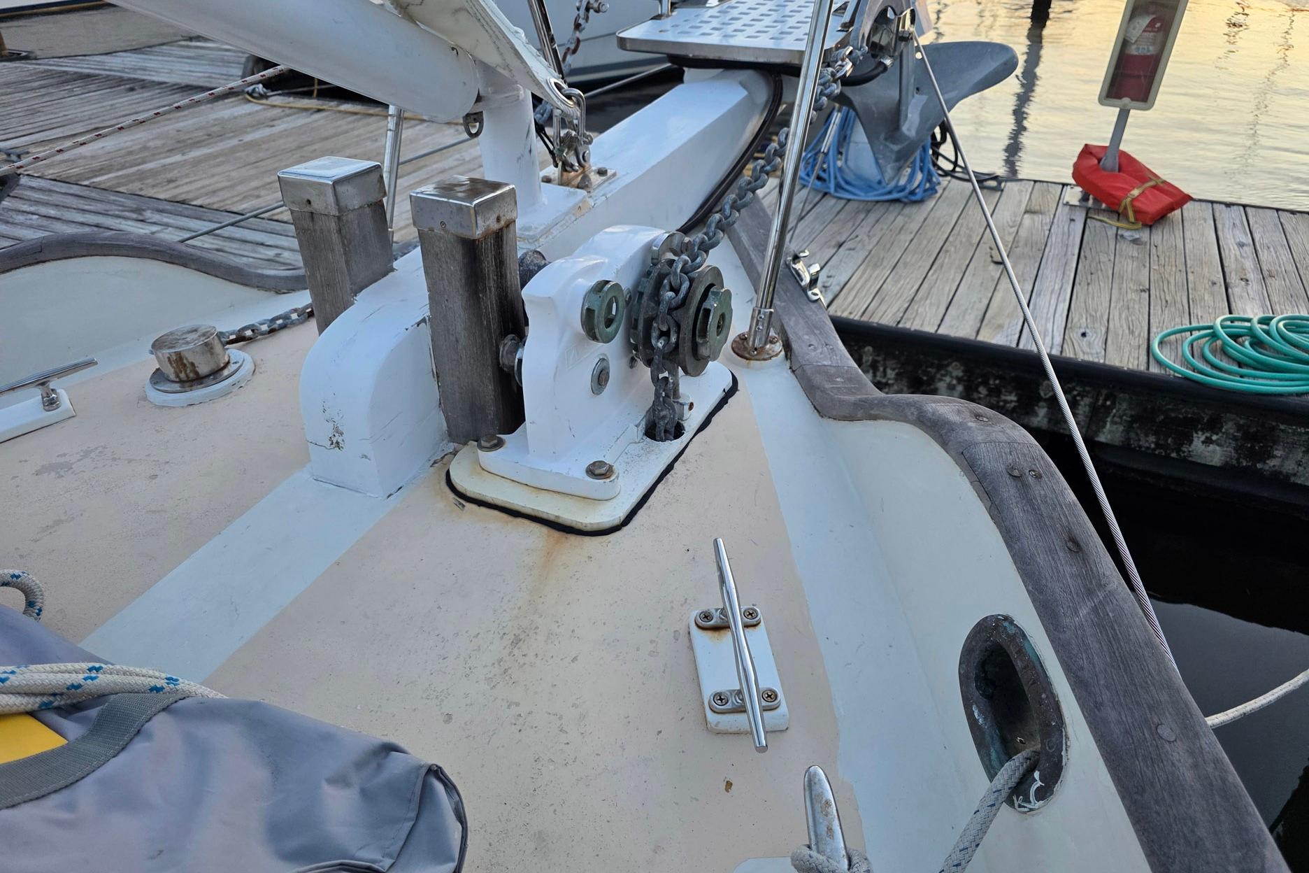Deck view of a 1982 Tayana 37 sailboat docked at a marina.