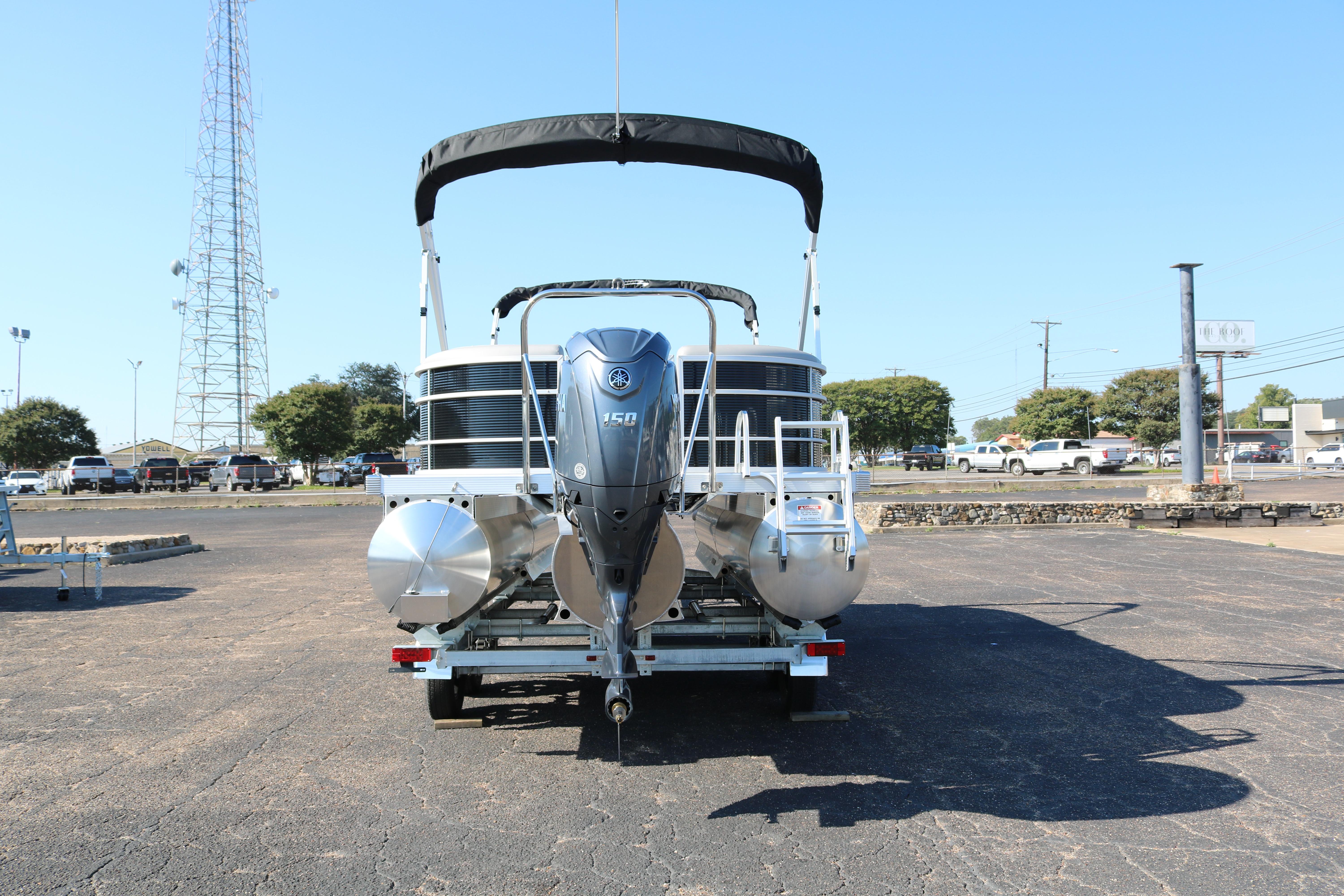 2026 Bennington 22SX Stern Radius pontoon boat with Yamaha 150 engine on trailer.