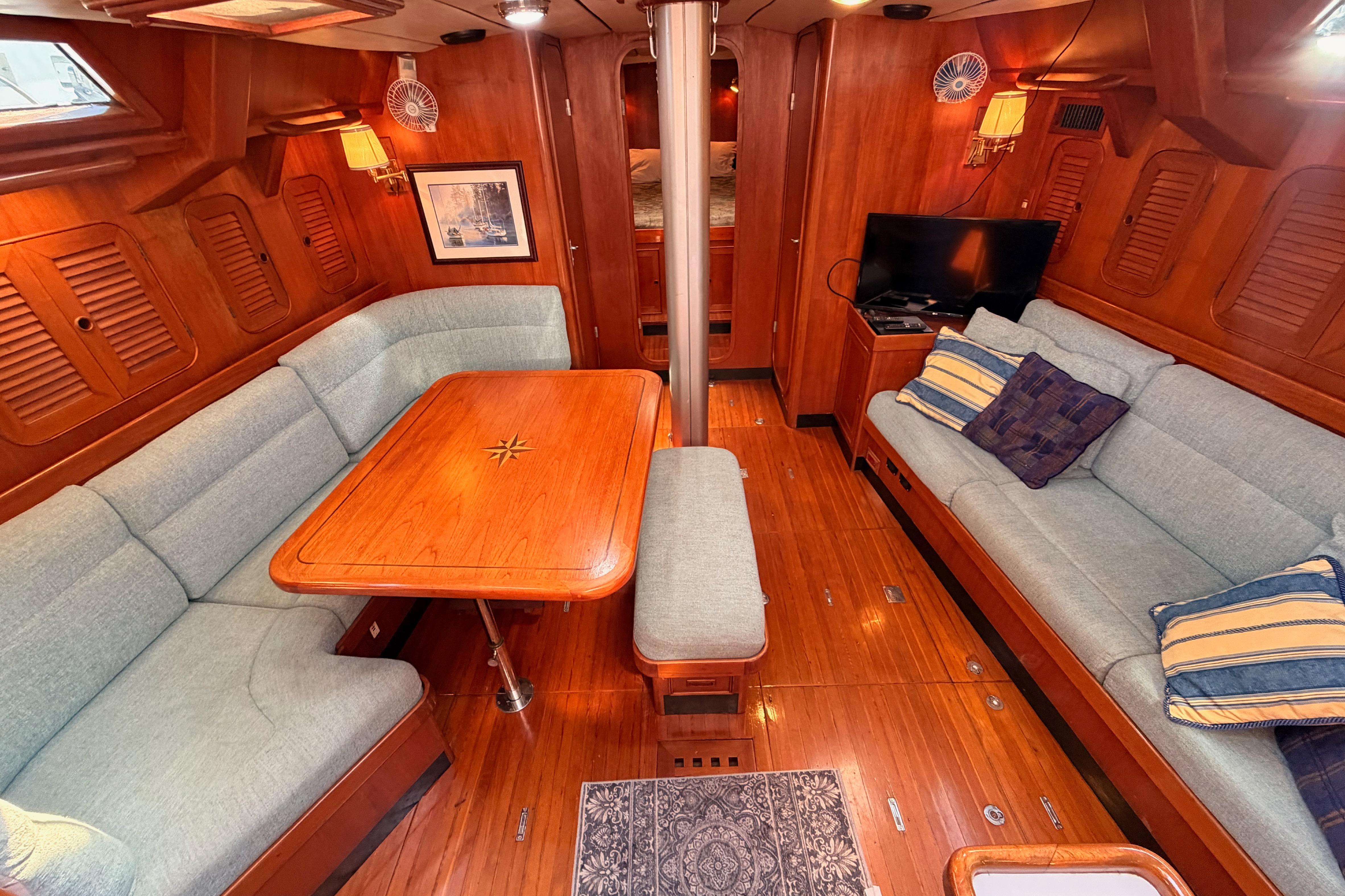 Luxurious 1991 Hylas 51 yacht interior with elegant wood finish and comfortable seating.