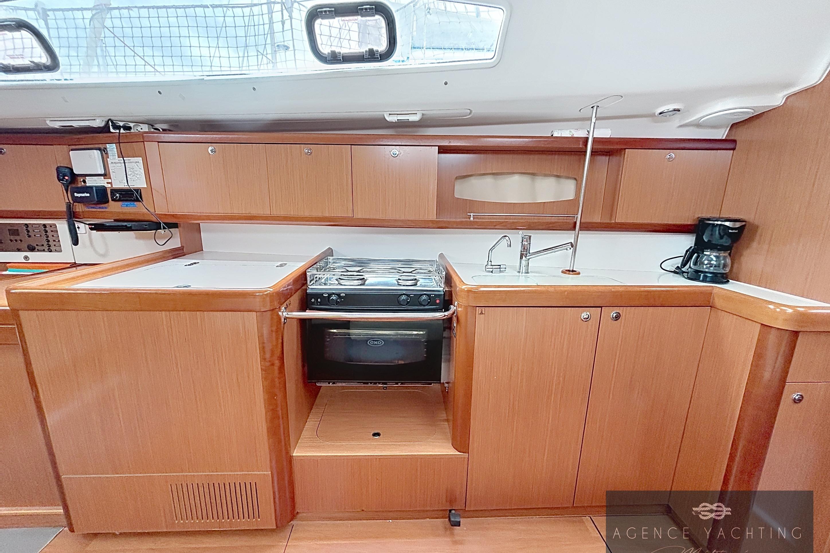 Interior view of 2008 Beneteau Oceanis 40 yacht kitchen with stove and sink.