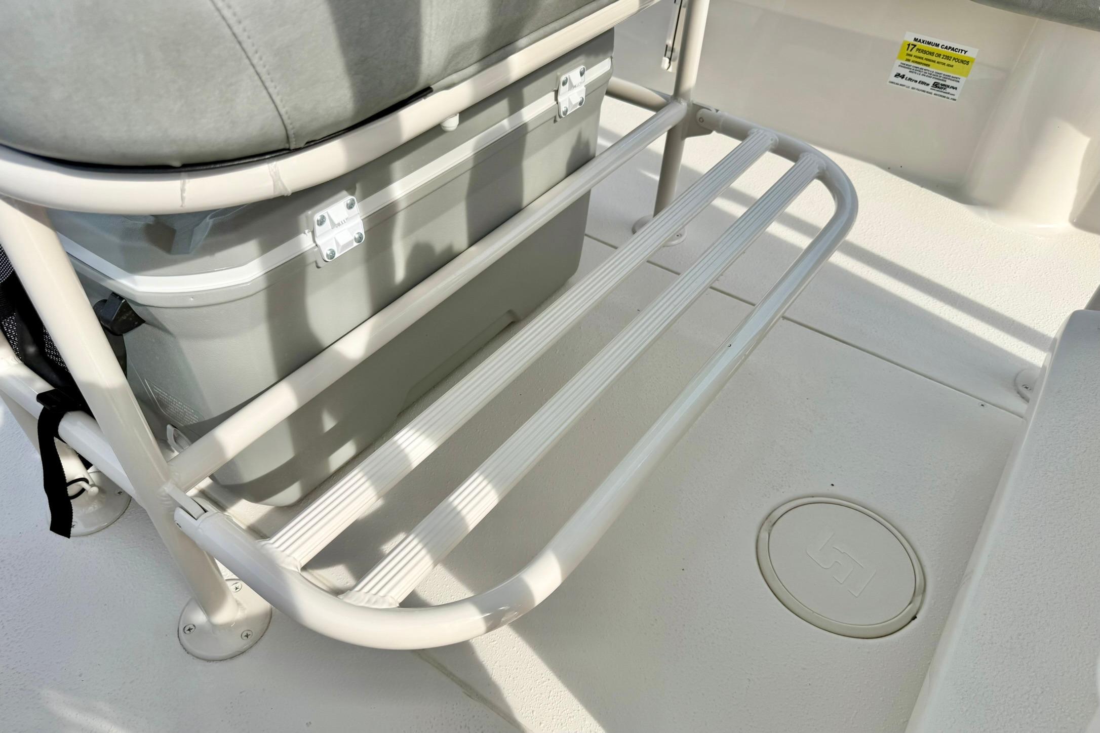 2026 Carolina Skiff 24 Ultra Elite boat interior with cooler and seating area.