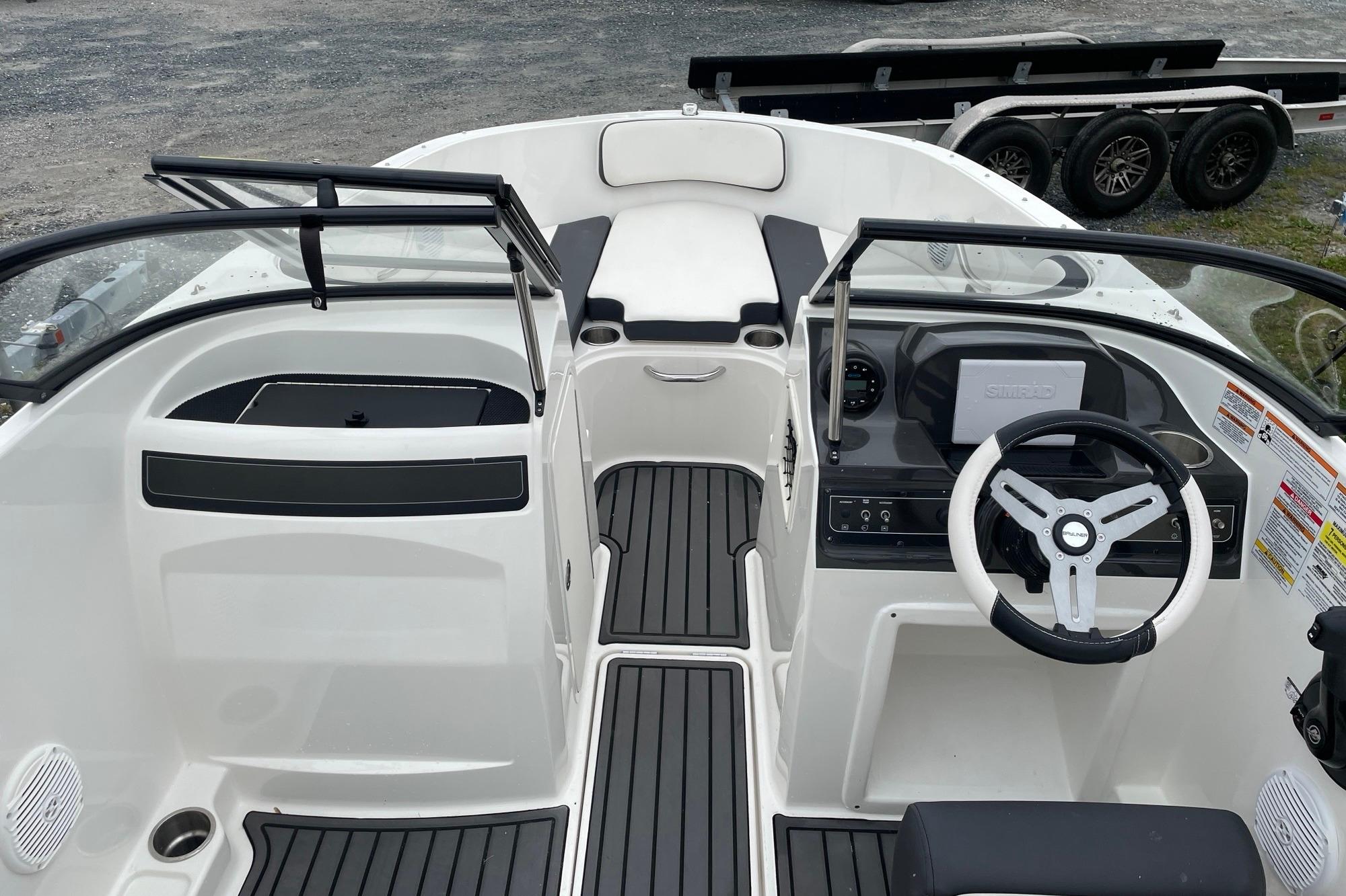2023 Bayliner VR4 Bowrider OB interior with steering wheel and seating area.
