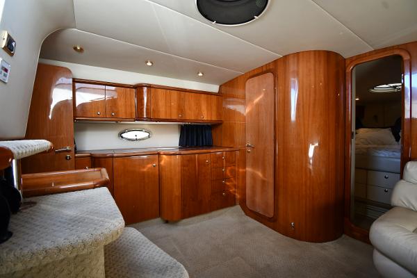 Luxurious interior of 1997 Sunseeker Camargue 47 yacht with polished wood finish.