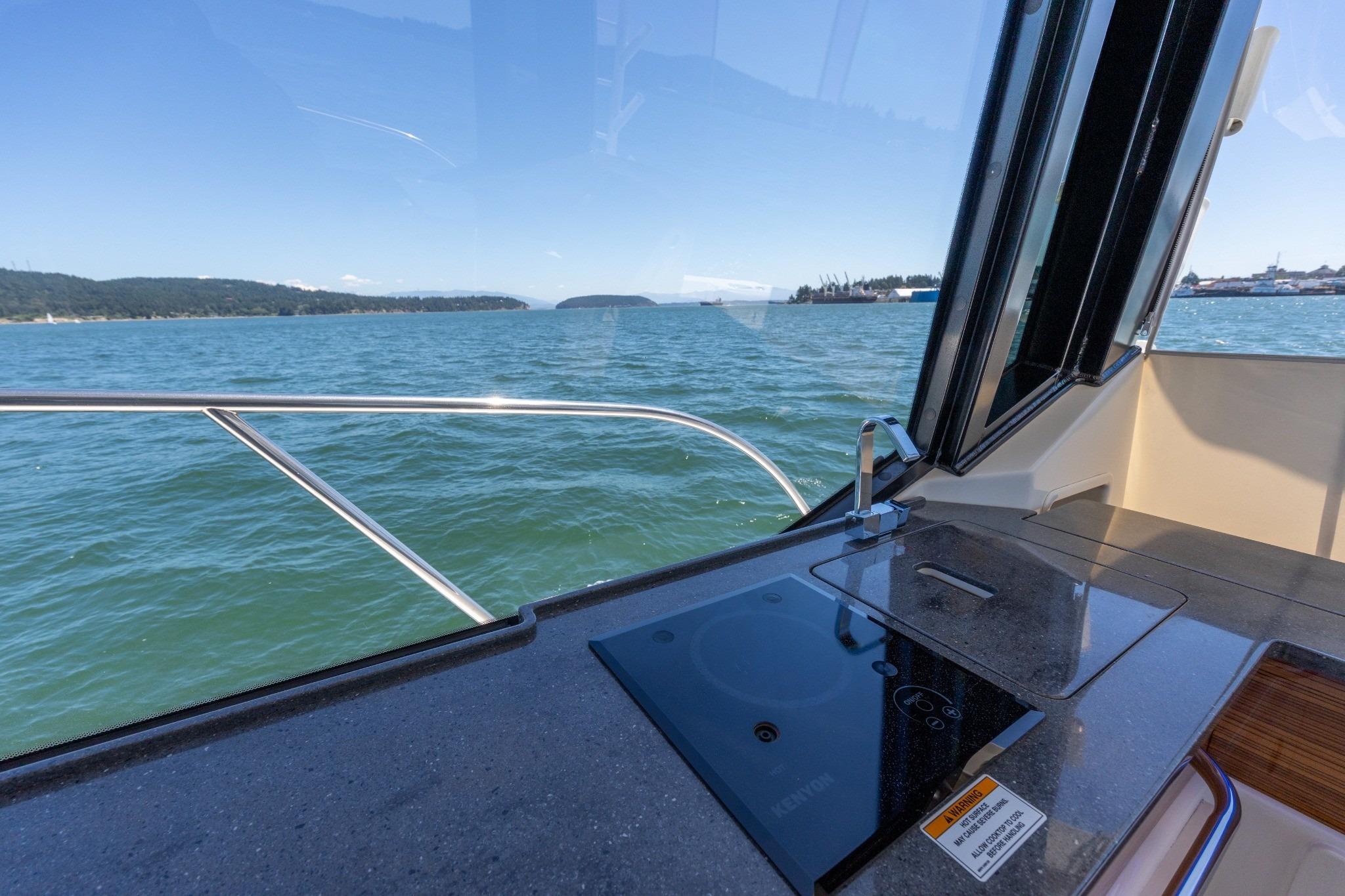 Interior view of 2023 Boston Whaler 405 Conquest yacht with ocean backdrop.