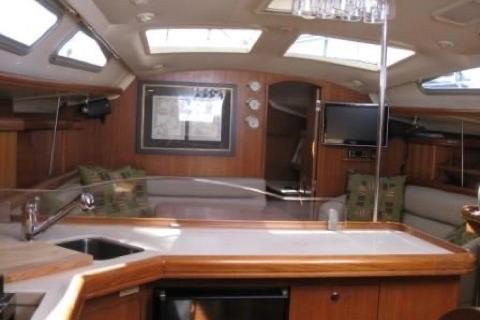 Interior of 2005 Hunter Marine 41 sailboat with modern kitchen and cozy seating area.