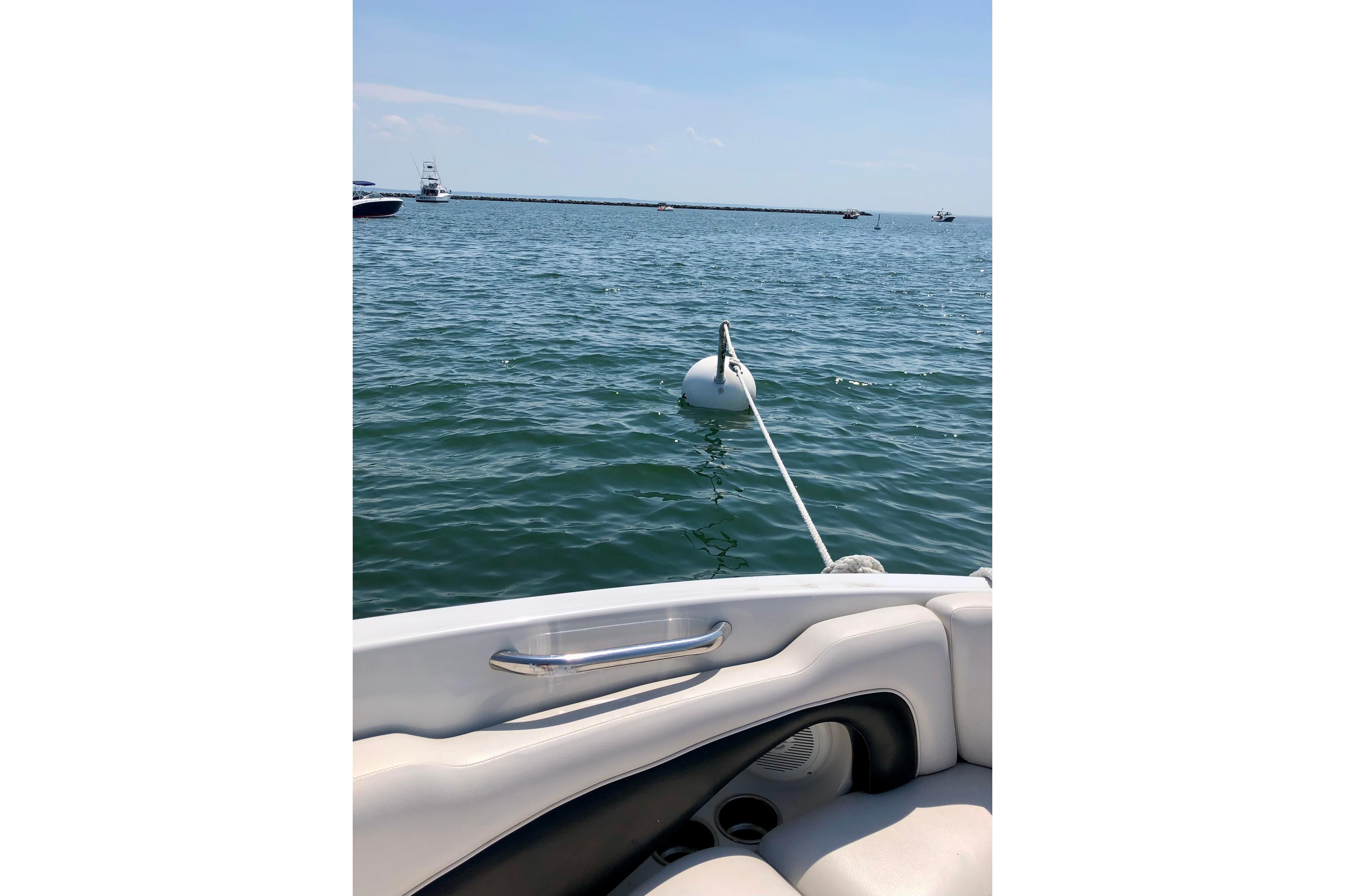 2013 Crownline Eclipse E4 boat on water, moored with buoy in sunny weather.