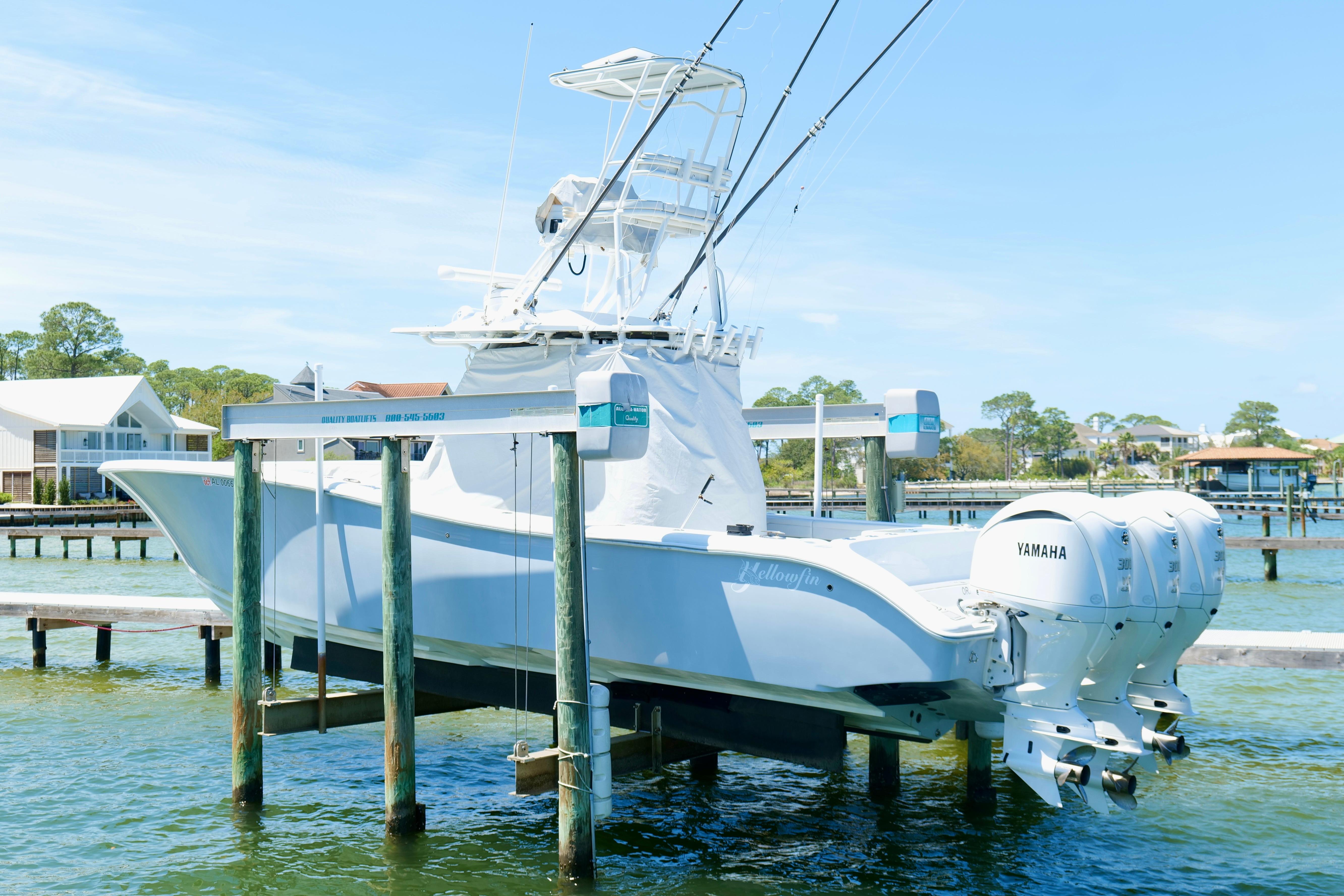 2018 Yellowfin 36 Offshore boat with triple Yamaha engines on a lift.