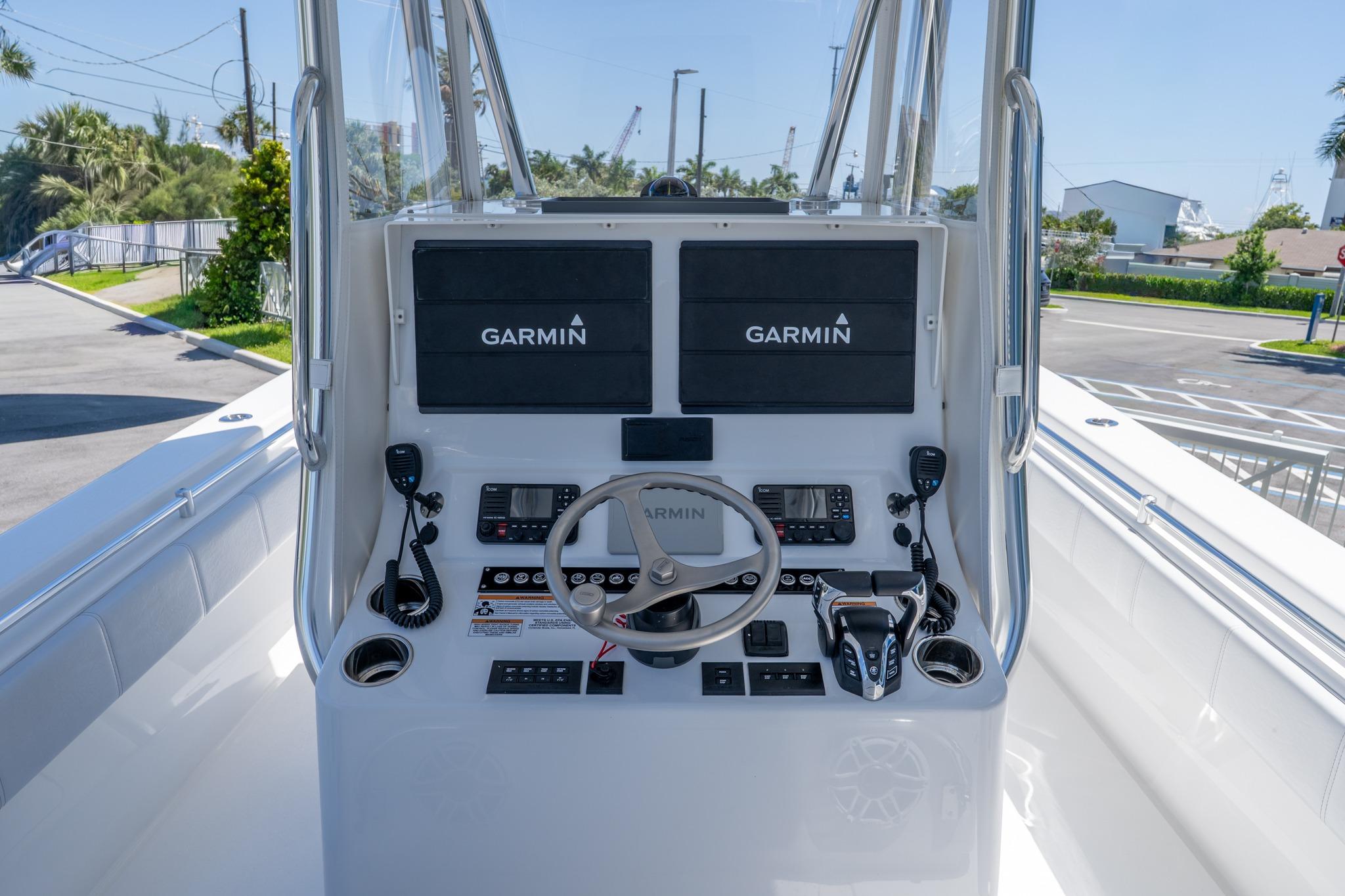 2024 Contender 35 ST boat console with Garmin navigation systems and steering wheel.