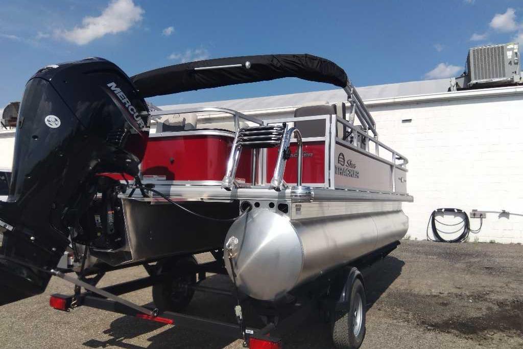 2026 Sun Tracker Bass Buggy 18 DLX pontoon boat with Mercury engine, parked outdoors.