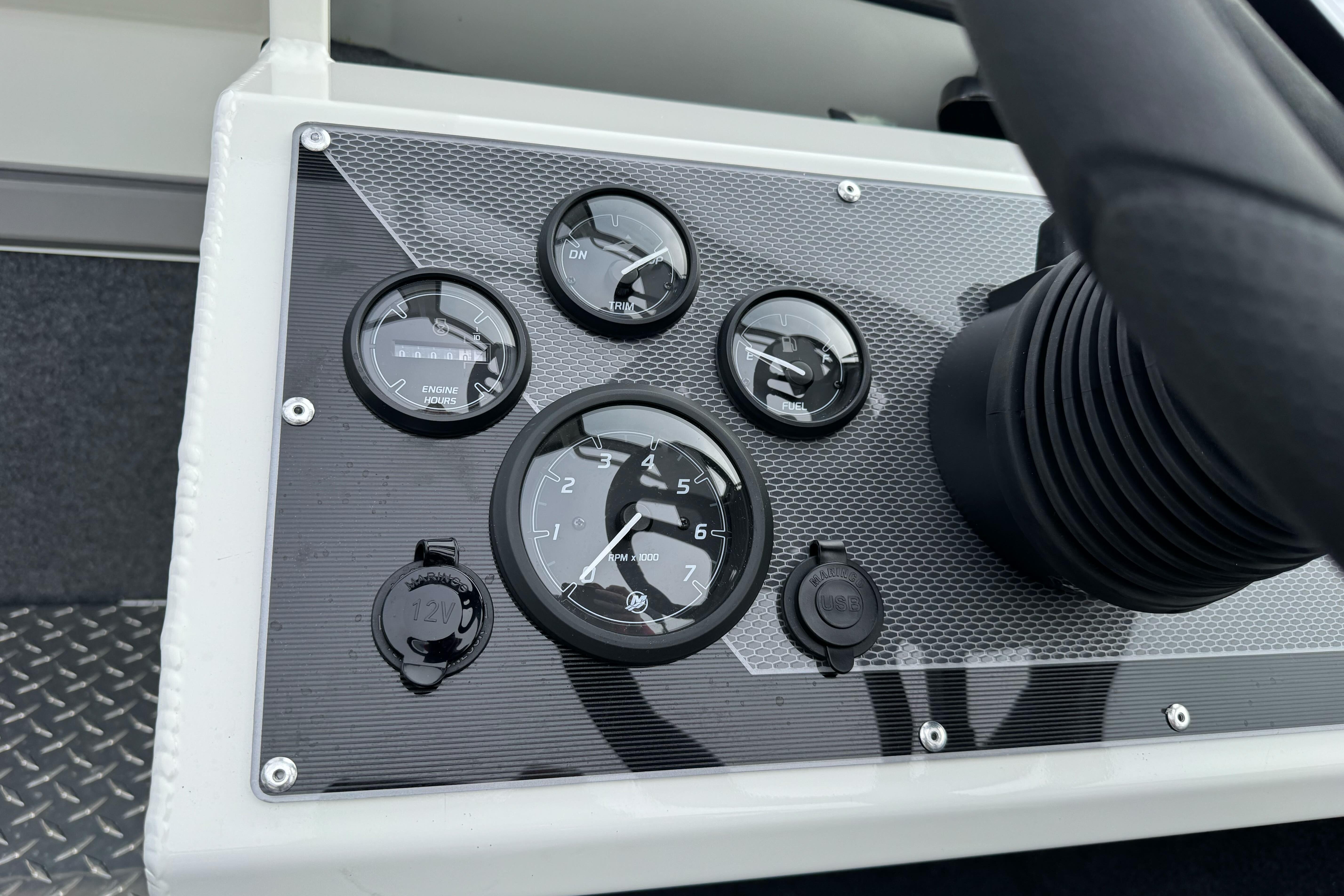 Dashboard of 2026 Lund 185 Heavy Gauge boat with gauges and controls.