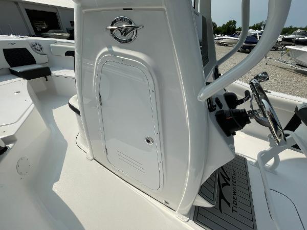 2025 Tidewater 232 CC Adventure boat interior with steering console and seating area.