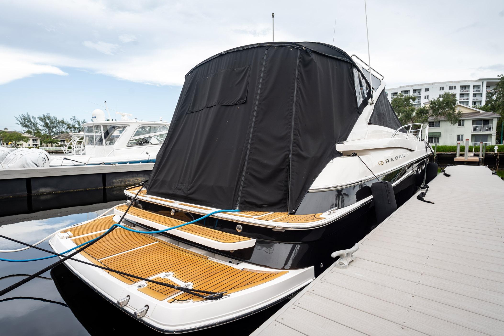 2008 Regal Commodore 4460 yacht docked, featuring sleek design and covered deck.