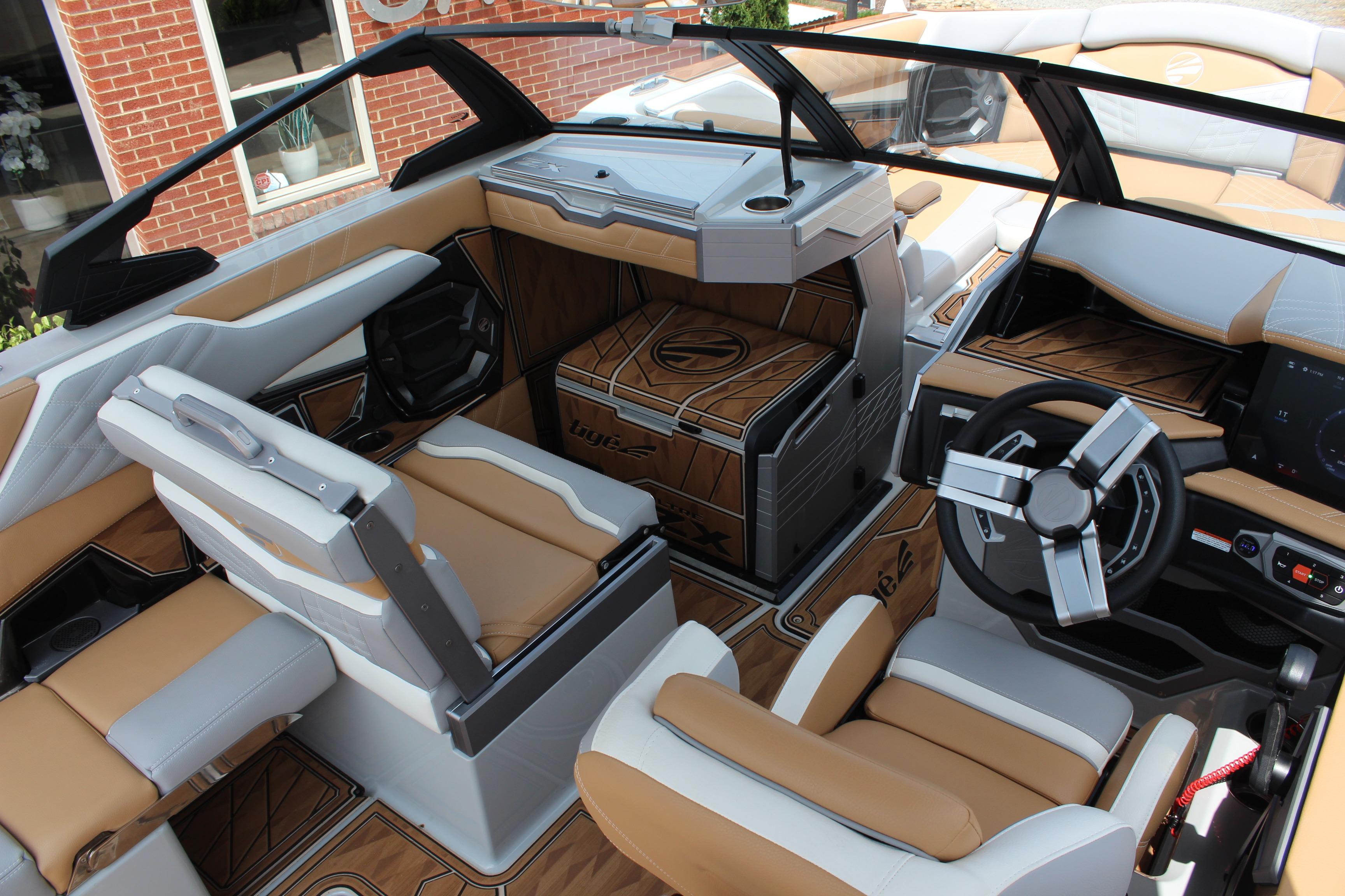 2024 Tigé Ultré 25ZX boat interior with luxurious tan and white seating, modern dashboard.
