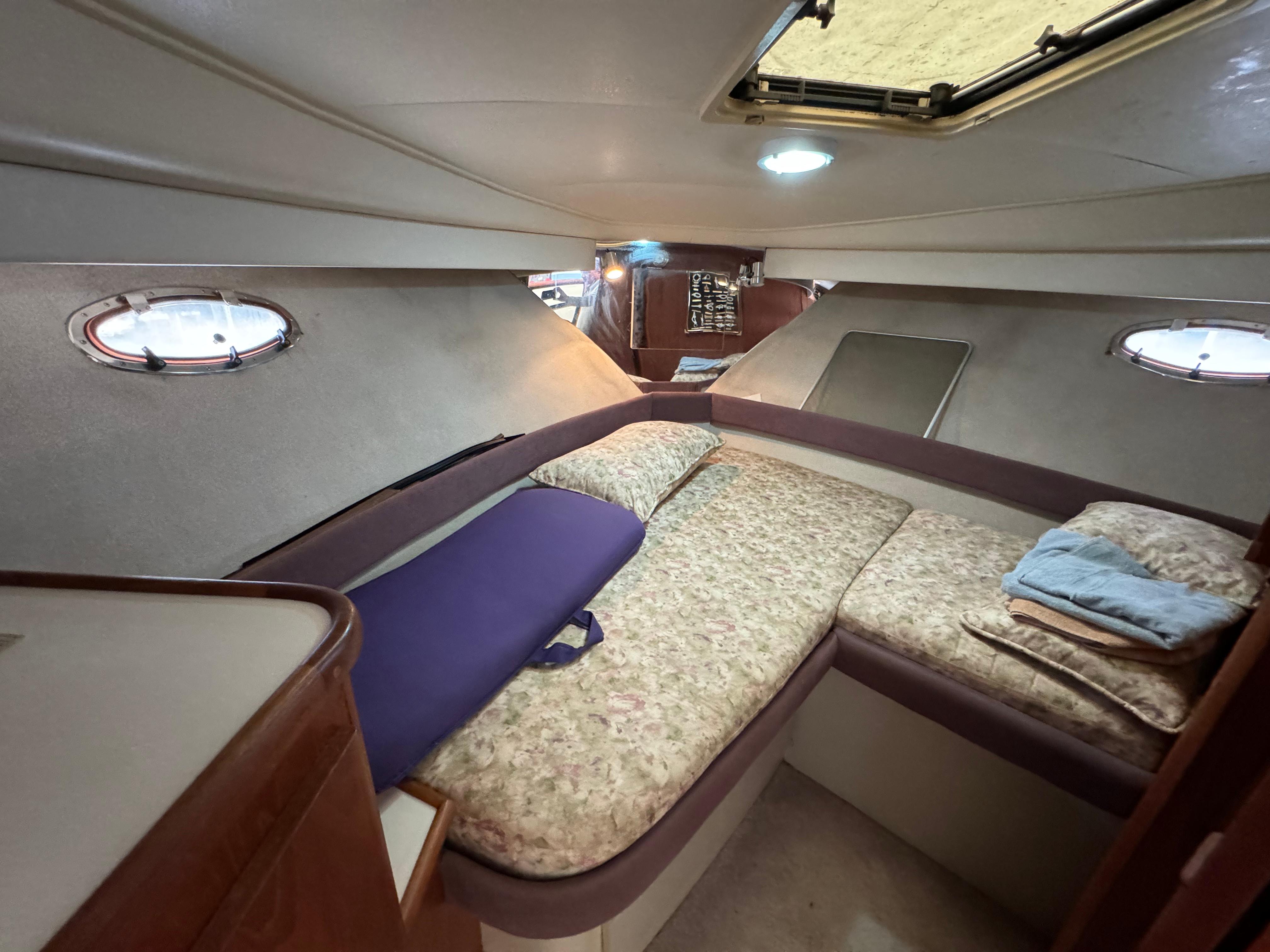 1991 Carver 33 Aft Cabin interior with cozy sleeping area and porthole windows.