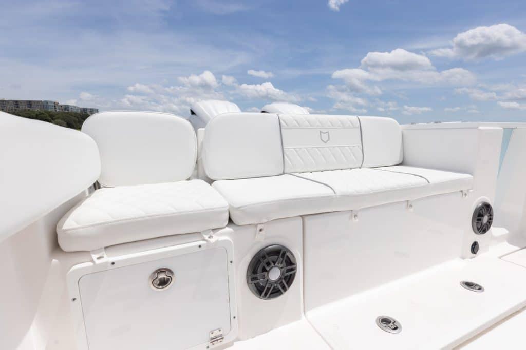 2027 Sea Fox 268 Commander boat with white cushioned seating and built-in speakers.