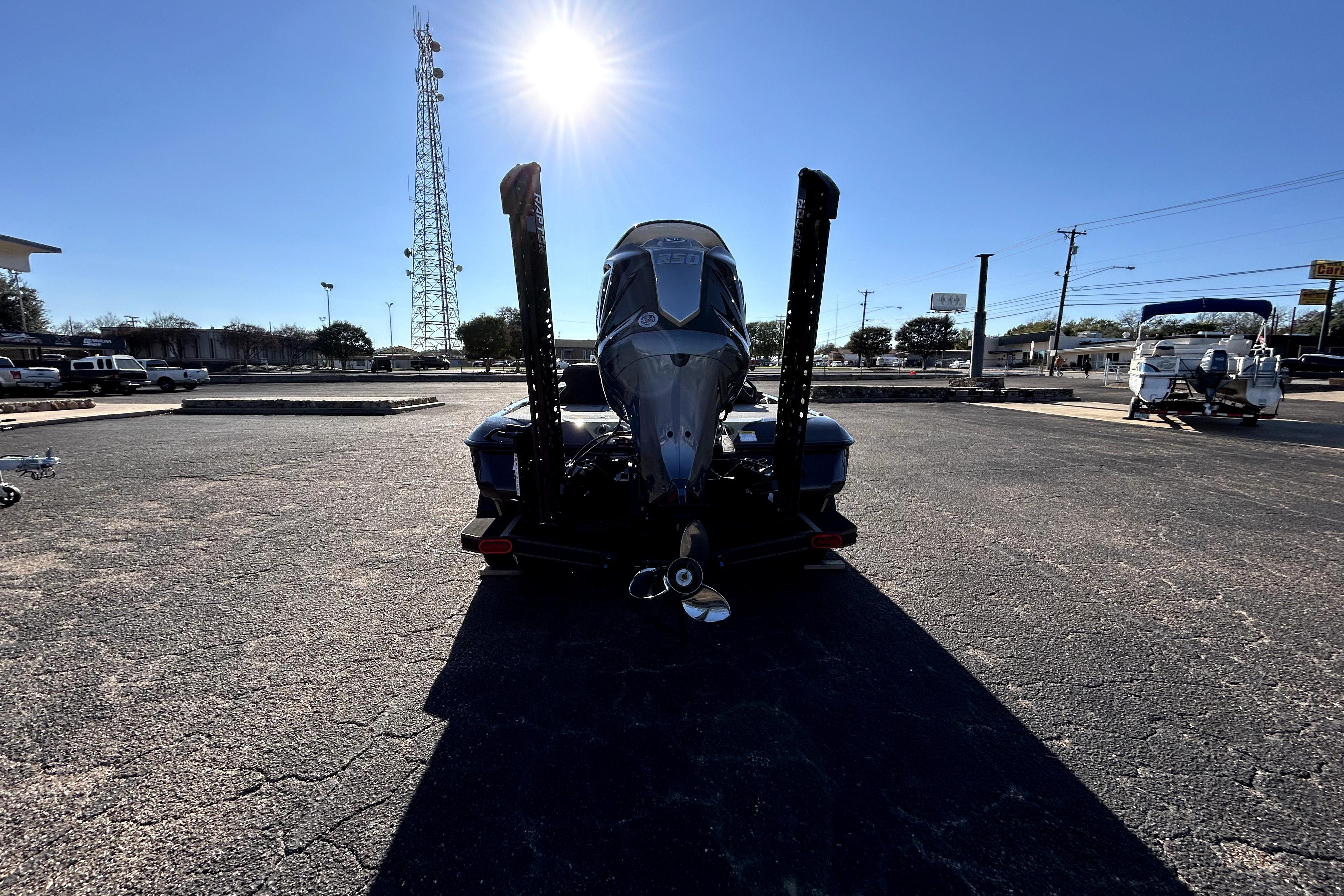 2026 Skeeter ZXE21 boat rear view under bright sun in parking lot.