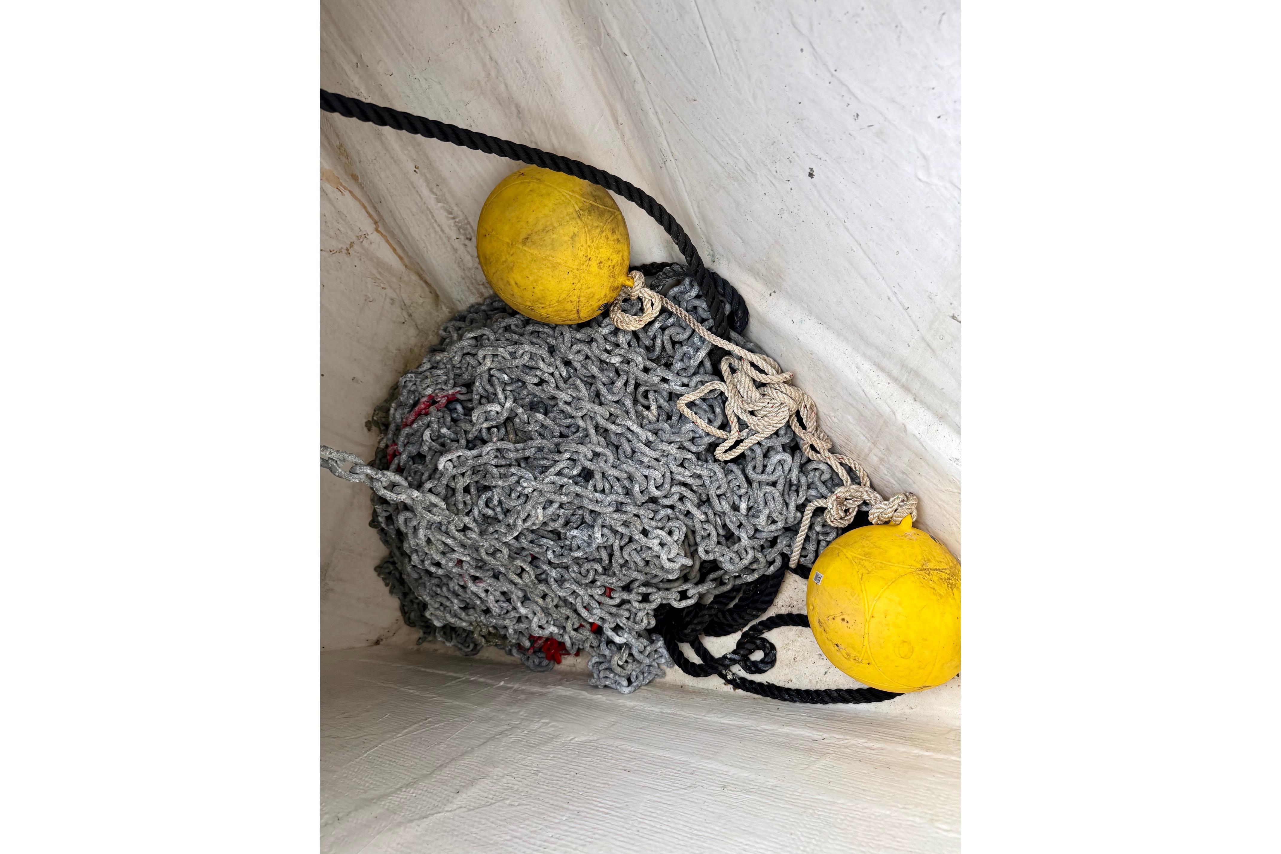 Coiled chain and yellow buoys on 2003 Tiara Yachts 3500 Open deck.