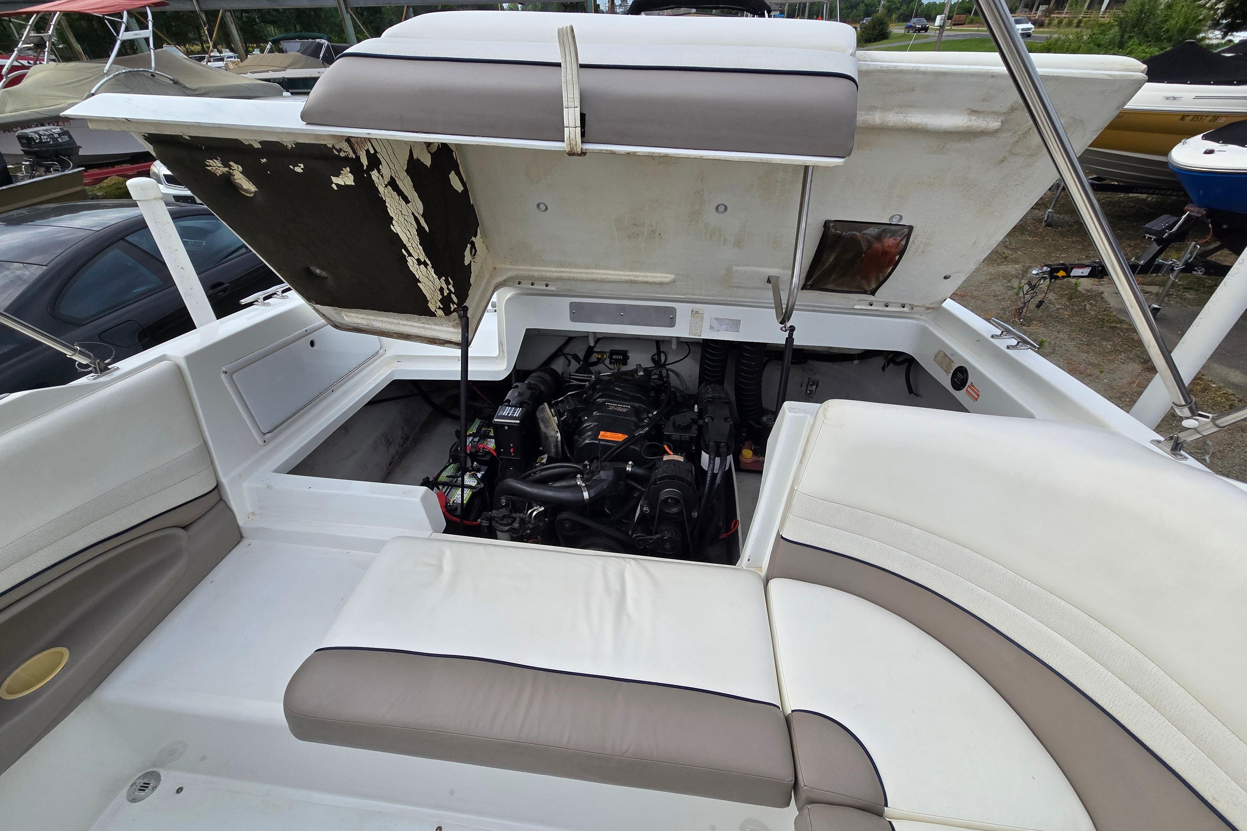 Open engine compartment of a 2000 Cobalt 246 boat, showcasing interior details.
