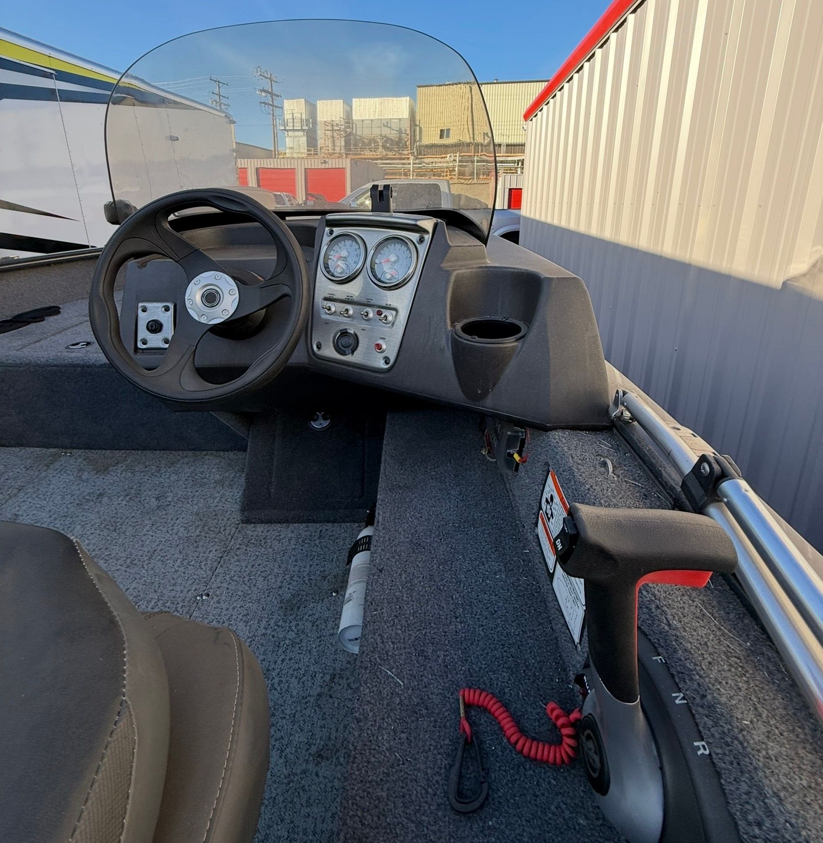 The image shows the cockpit of a 2021 Bass Tracker Pro Guide V 16 with steering and instruments.