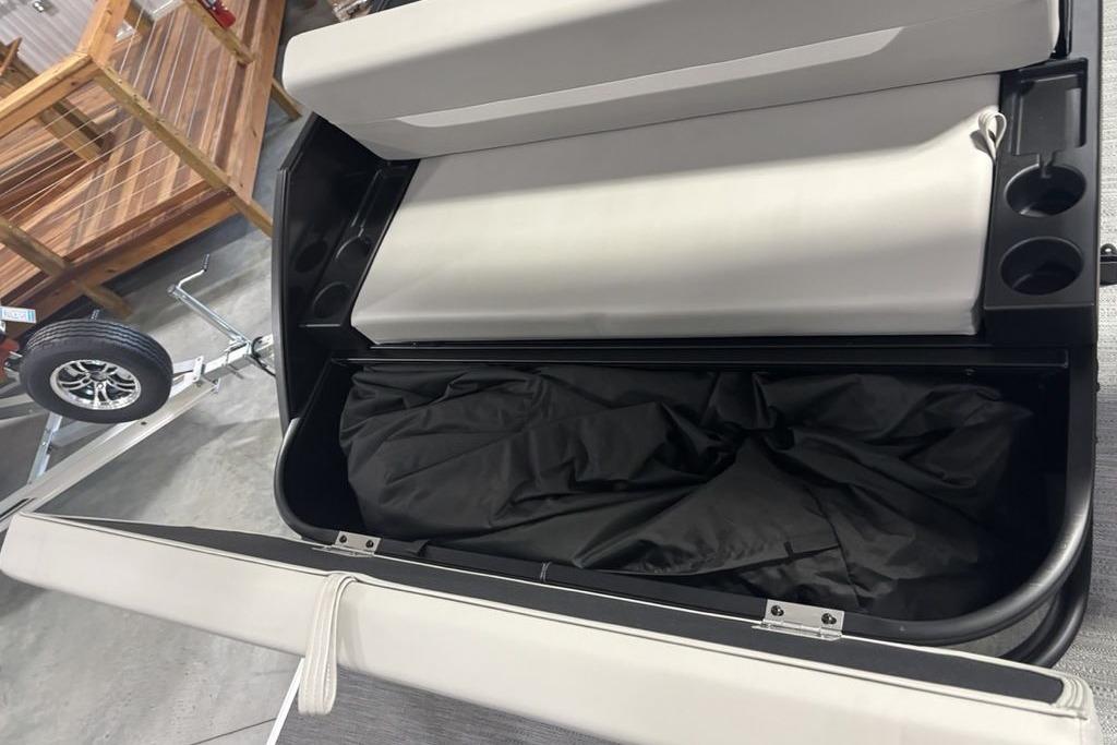 Storage compartment of 2026 Godfrey Xperience 2086 SFLX 25 in. Package, featuring cup holders.