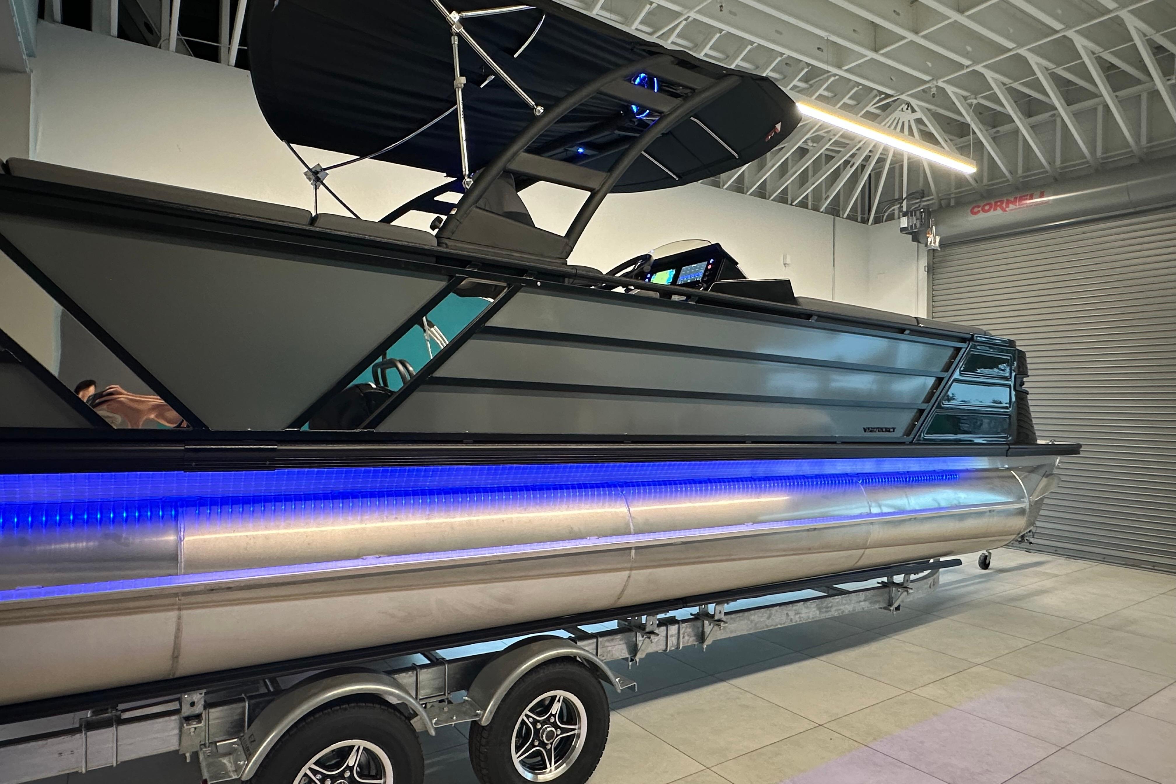 2025 Veranda VX 27 DCRC pontoon boat with sleek design and blue LED lighting.