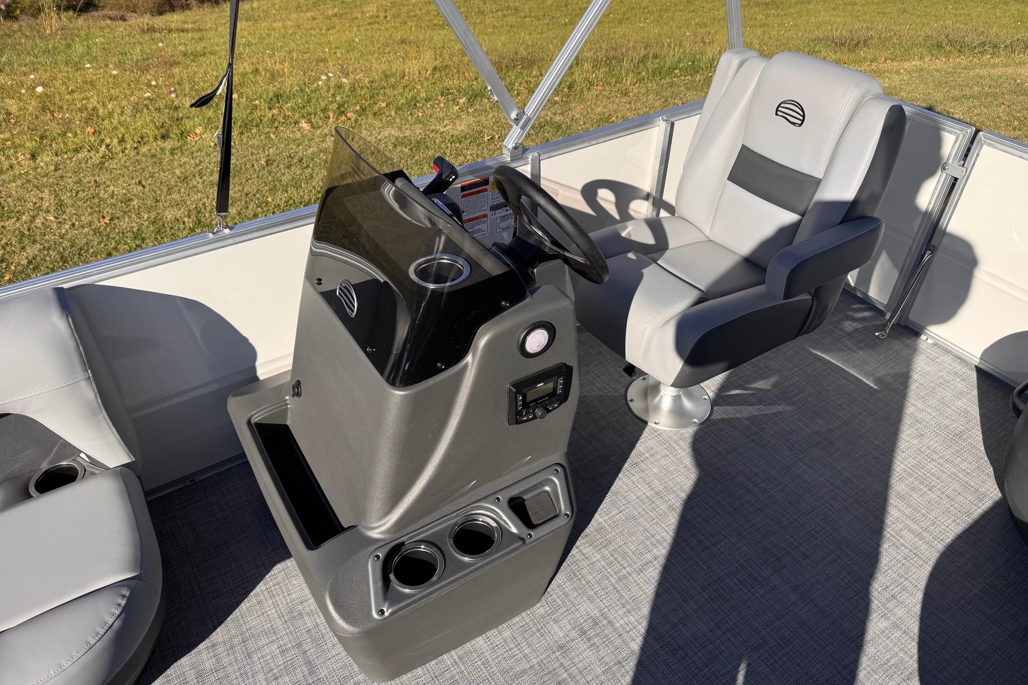 2026 Sun Tracker Party Barge 16 DLX interior with helm and seating.