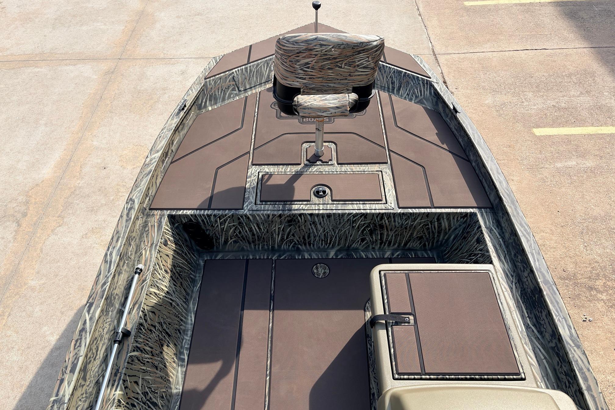 2026 Tracker Grizzly 1754 SC boat interior with camo design and seating.