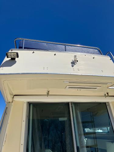 1985 Cruisers Yachts 338 Chateau Vee, upper deck view with clear blue sky.