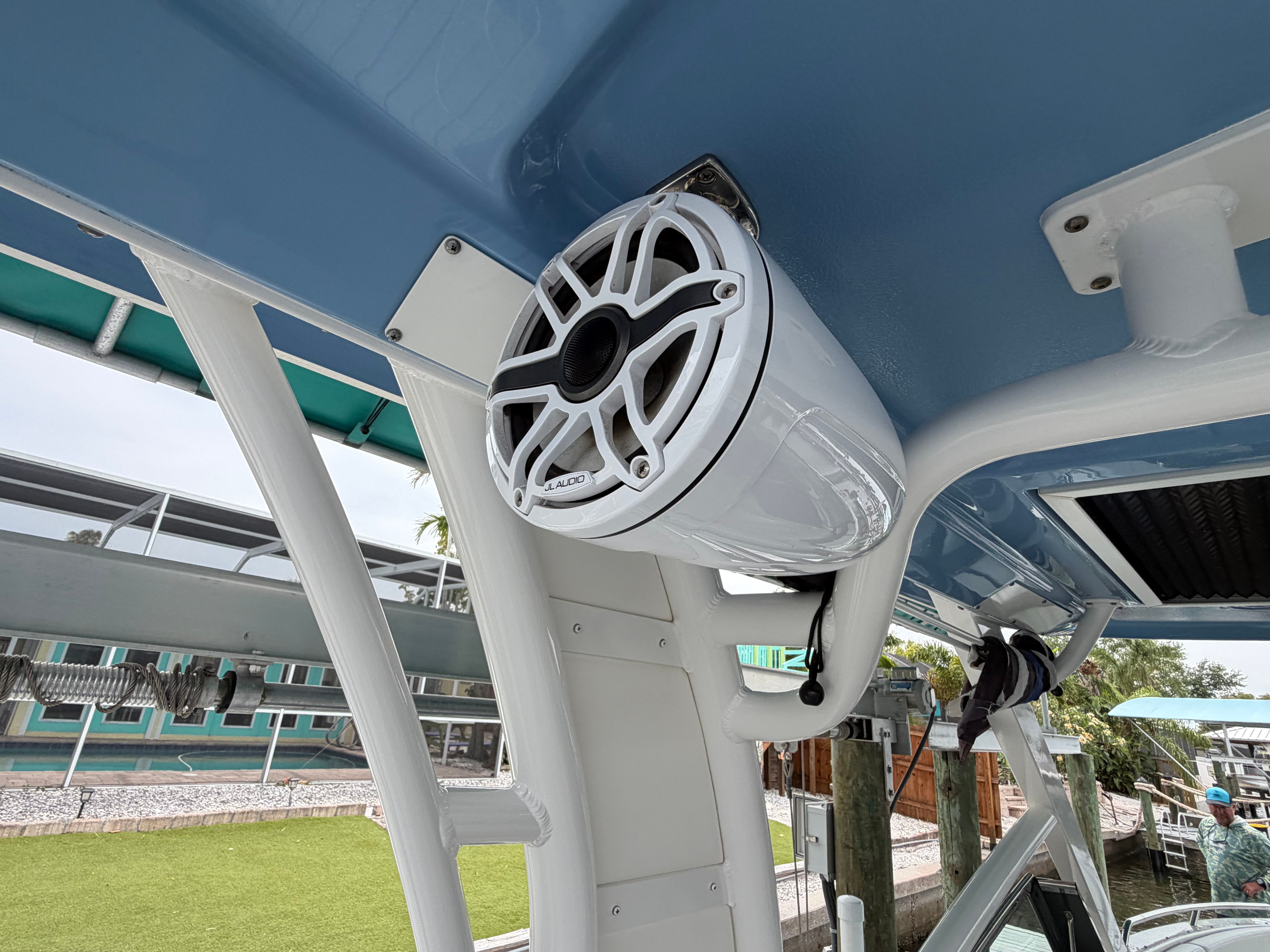 A speaker is mounted on the canopy of a boat.