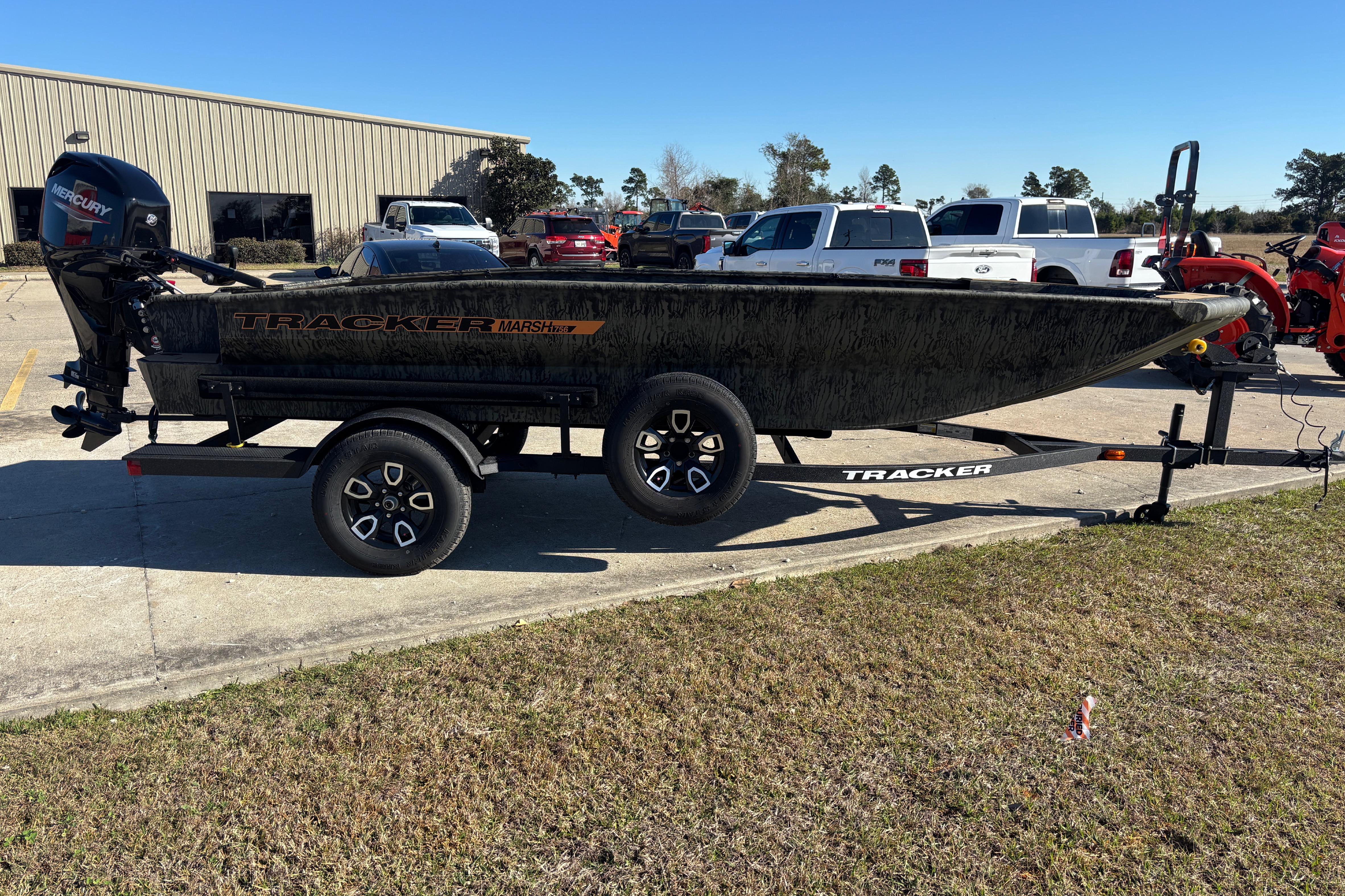 2026 Tracker Grizzly 1756 T Marsh boat on trailer in parking lot.