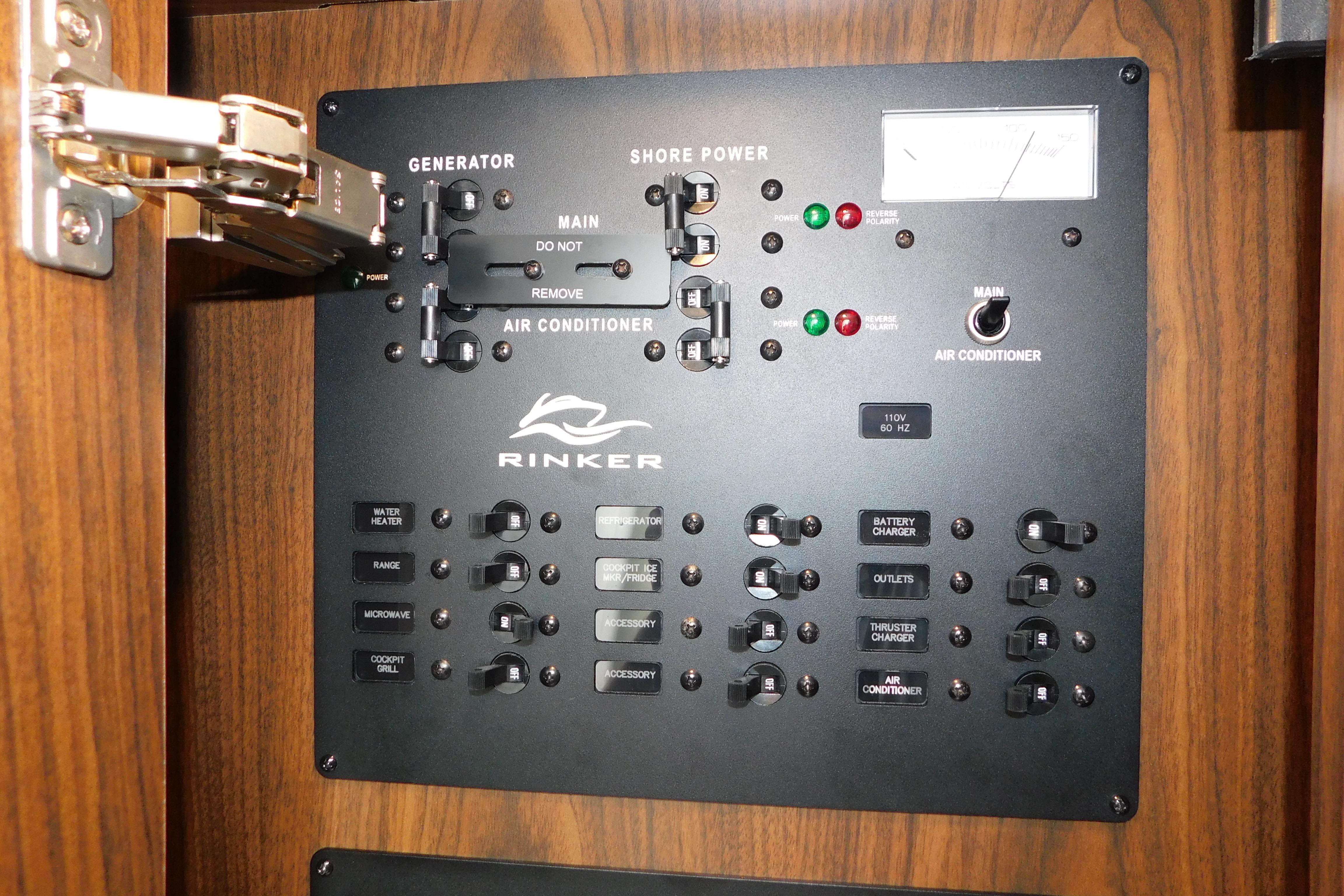 Electrical control panel of a 2017 Rinker EX 320 boat, featuring generator and shore power switches.