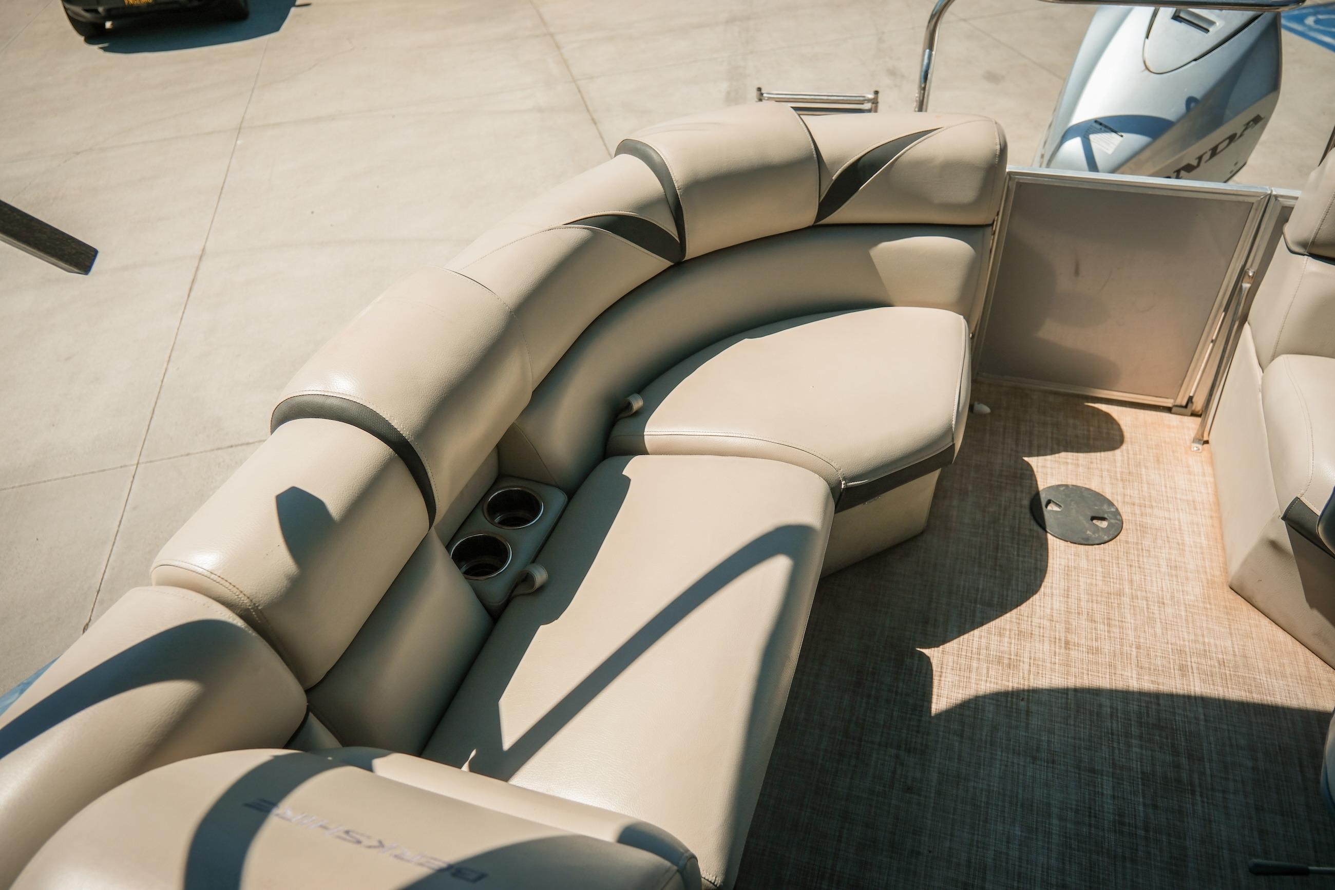 2019 Berkshire 25CLE STS boat interior with beige seating and cup holders.