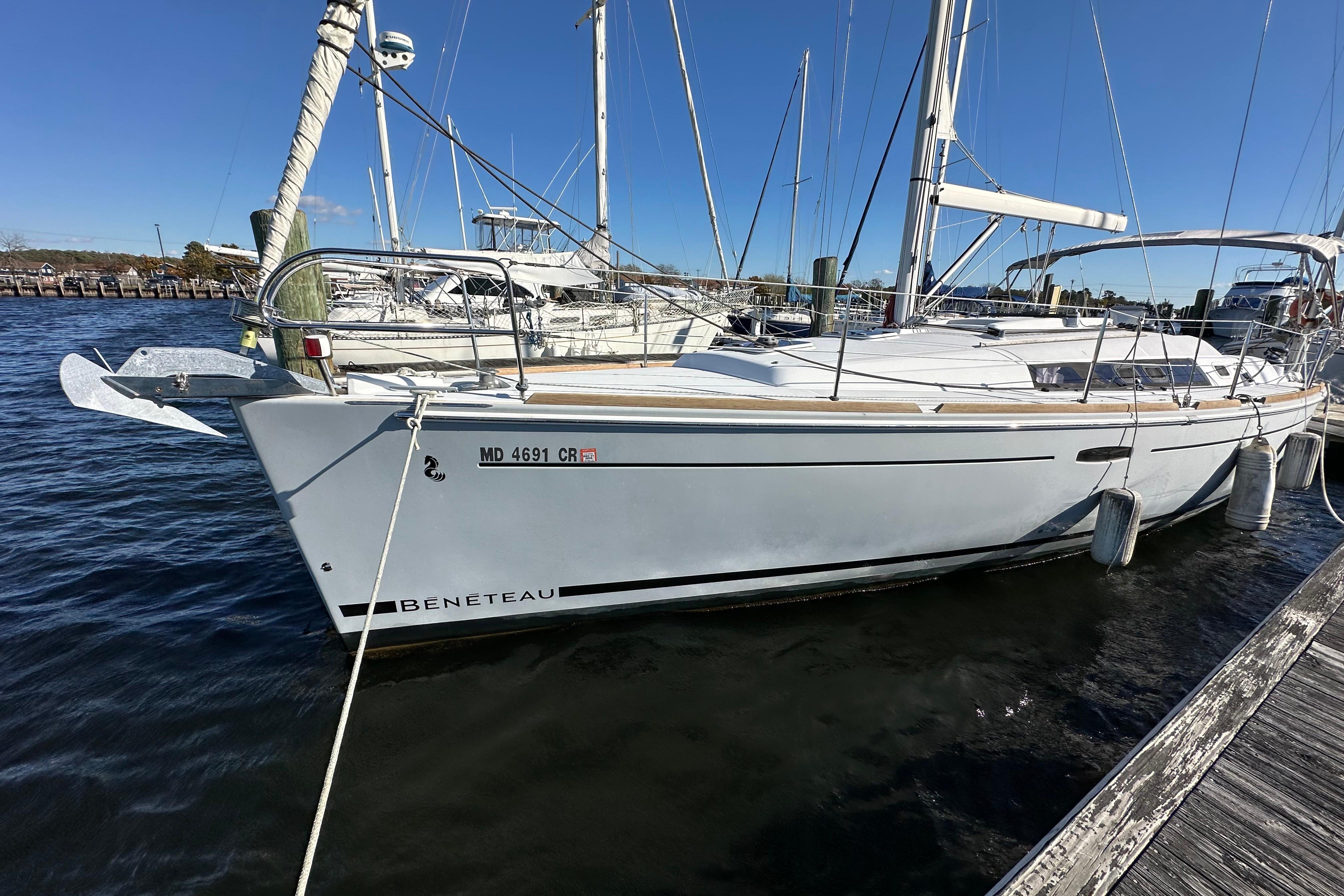 2015 Beneteau Oceanis 37 sailboat docked at marina on a sunny day.