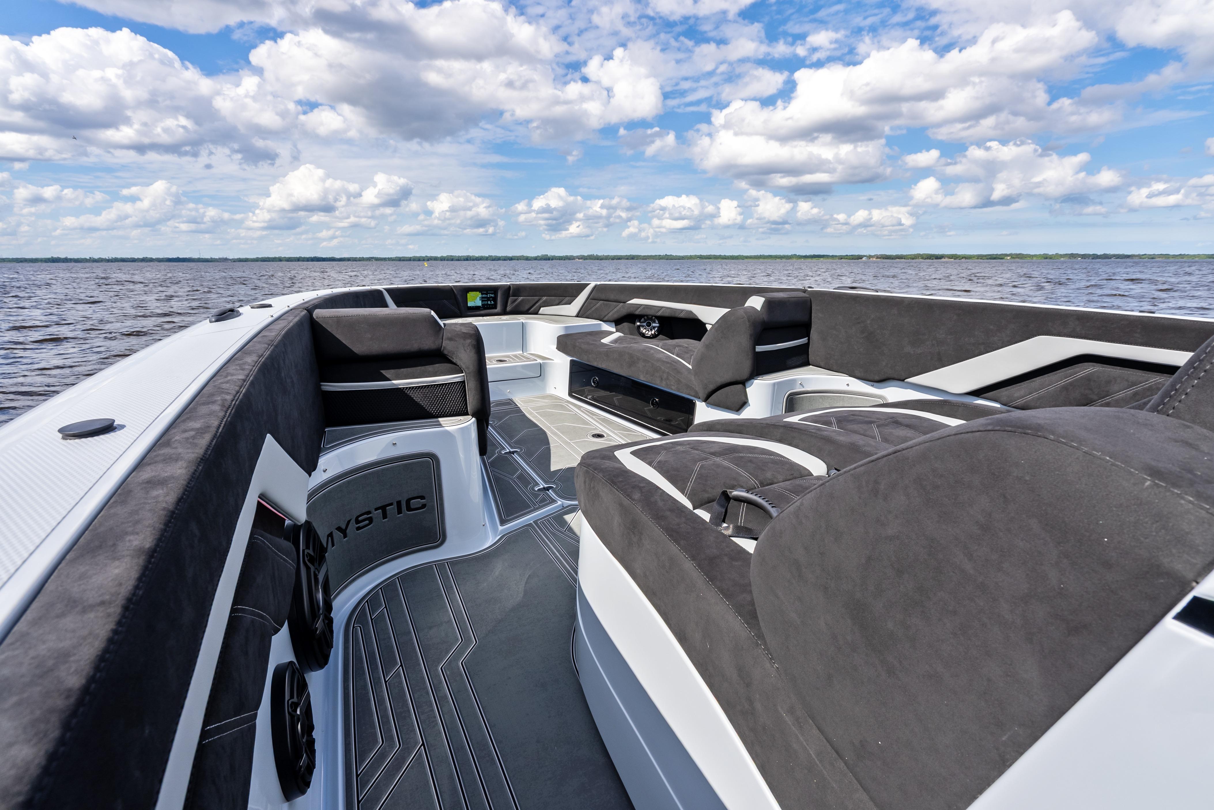 Luxurious interior of 2027 Mystic Powerboats M4200 on open water under a cloudy sky.