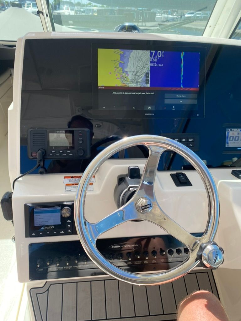 Cobia 330 boat helm, 2023 model, featuring navigation system.