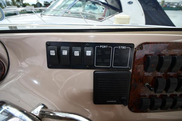 Control panel of a 2003 Sea Ray 460 Sundancer yacht with switches and Garmin device.