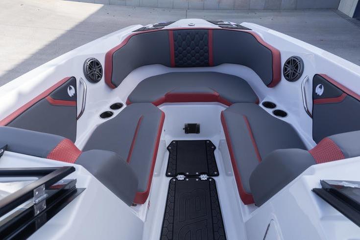 2026 Scarab 255 LX Wake boat interior with gray and red seating, cup holders, and speakers.