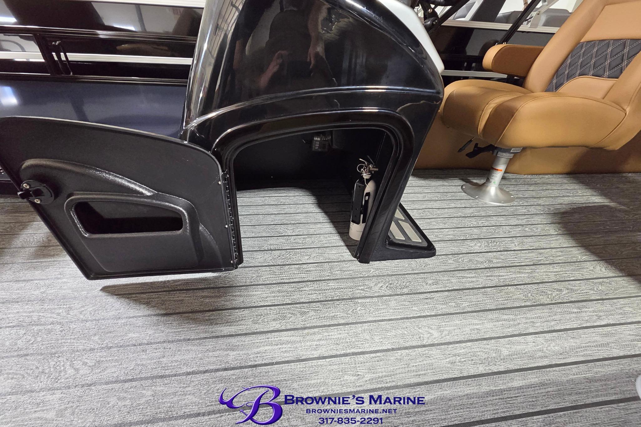 2026 Ranger 220F boat interior with open storage compartment and tan seating.