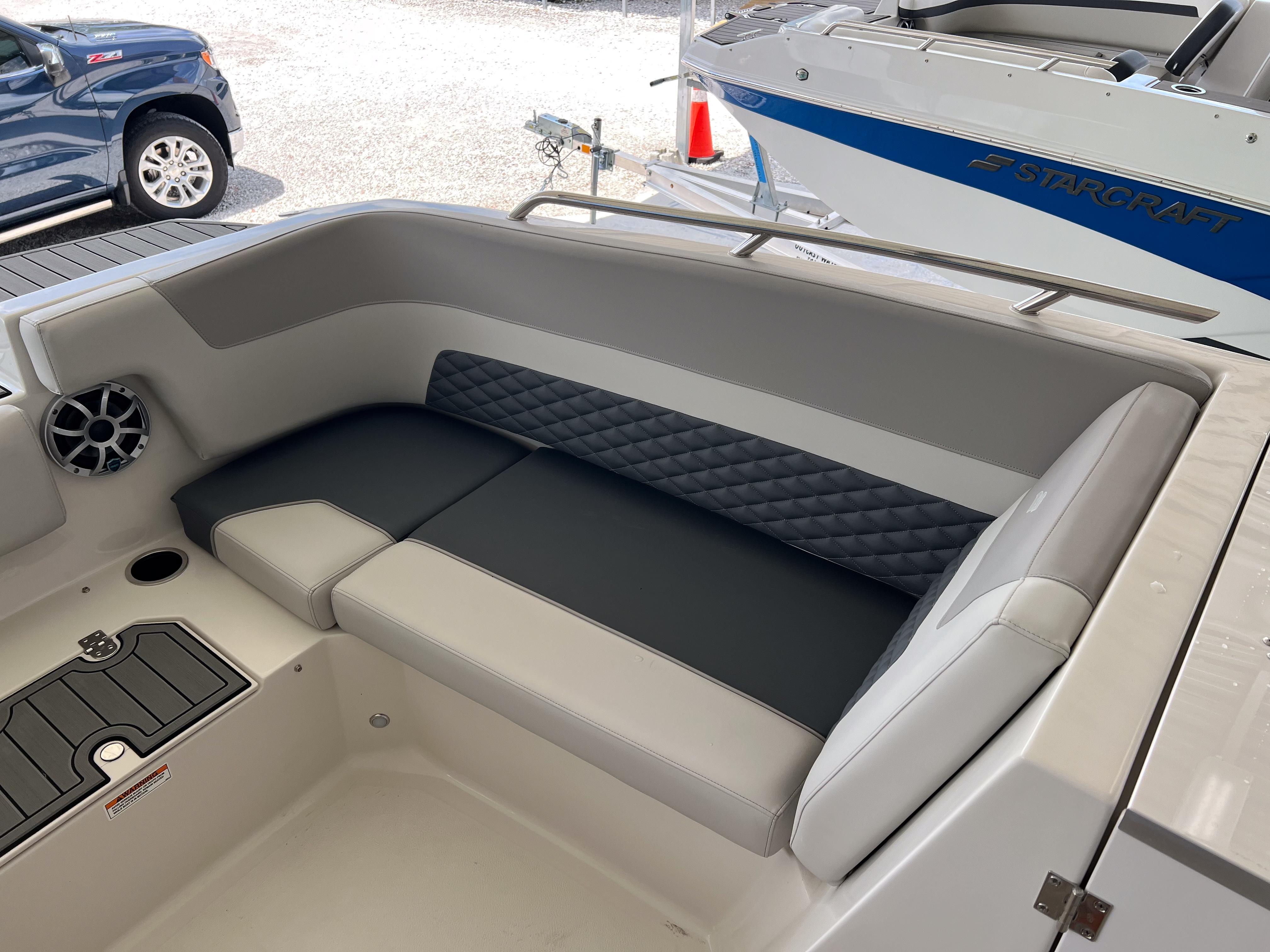2026 Starcraft SVX 231 OB boat interior with cushioned seating and speaker.