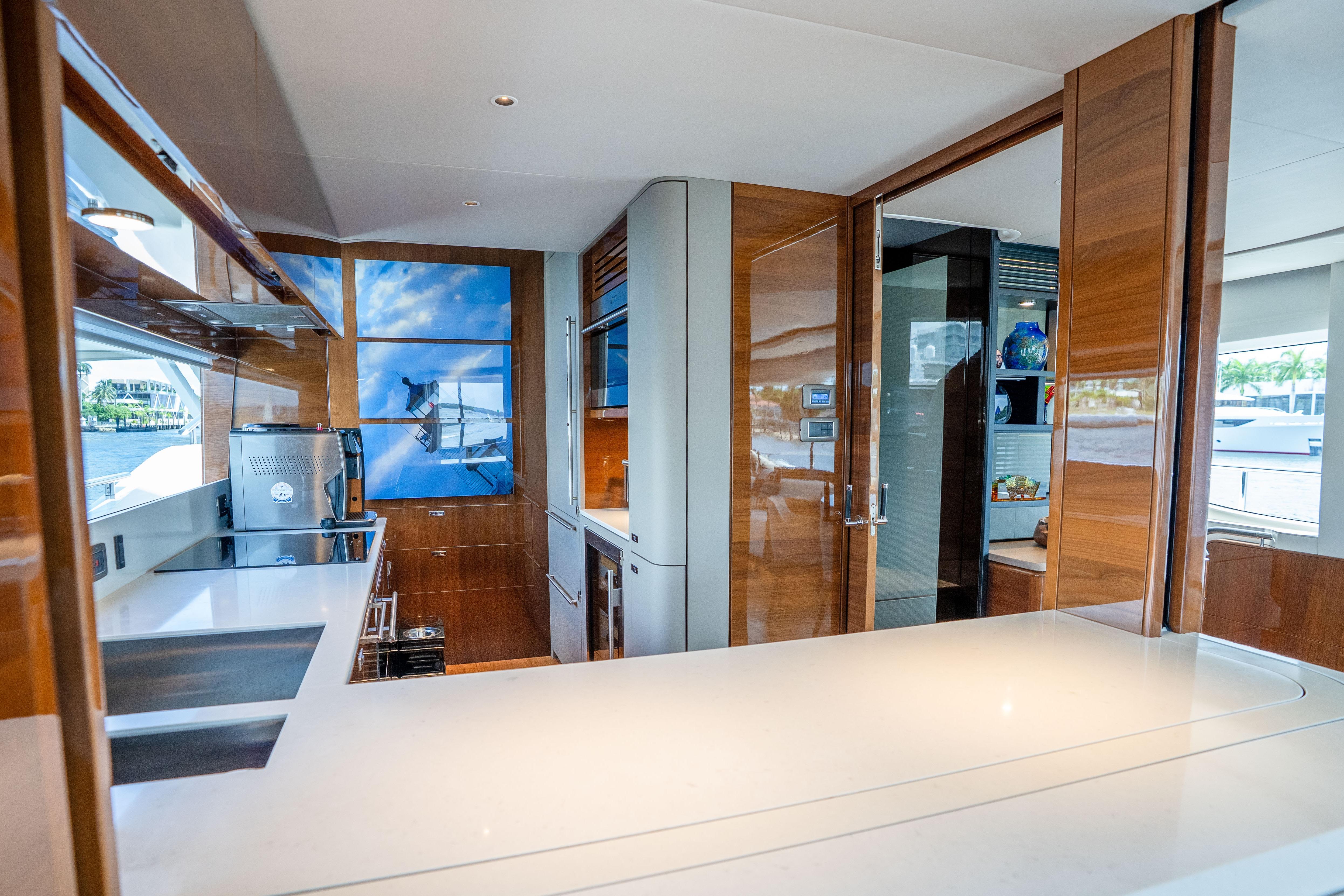 Luxurious kitchen interior of 2020 Princess Y85 yacht with modern appliances and sleek design.