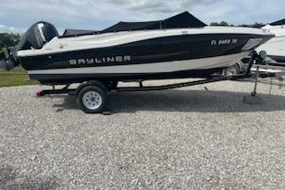 2013 Bayliner 190 Bowrider on trailer, parked on gravel surface.