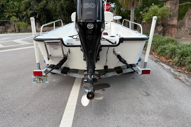 2016 Boston Whaler 150 Montauk boat on trailer, rear view with outboard motor.